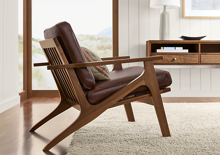Detail of Sanna chair in Portofino espresso leather with walnut base.