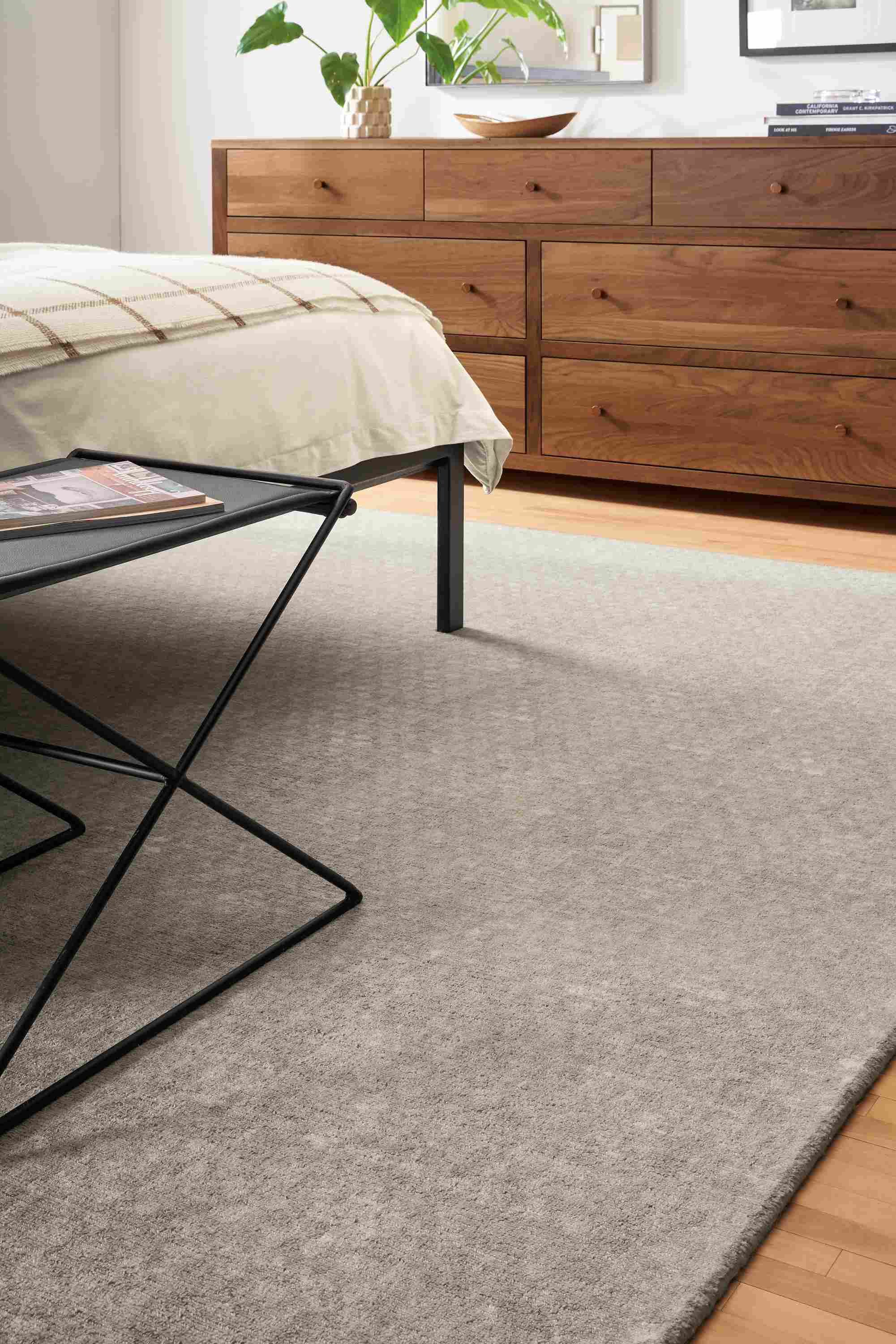 Detail of Saris 8x10 rug in grey in bedroom.