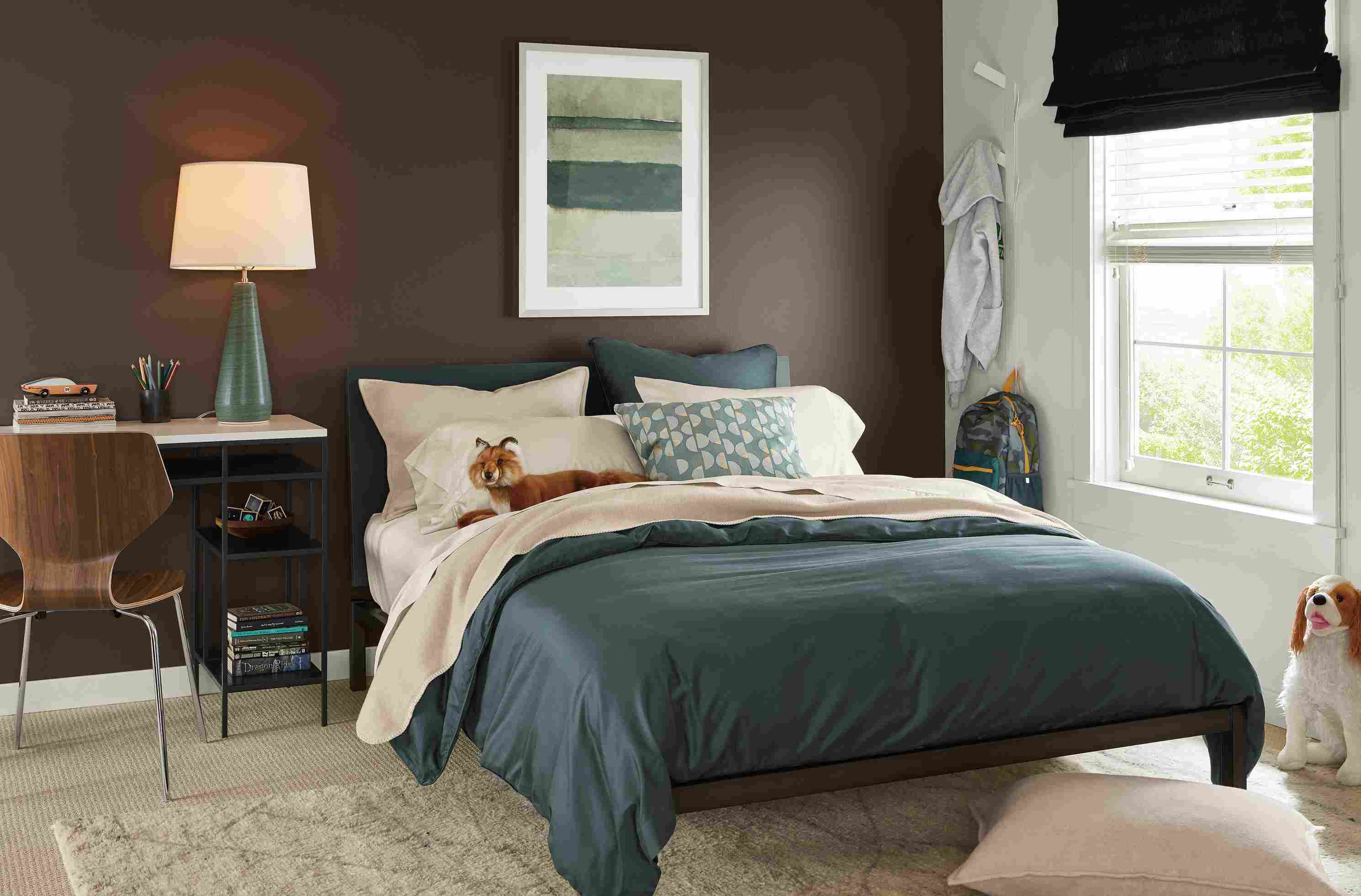 Bedroom with tailored sateen duvet cover in dark slate and sateen sheets in ecru.
