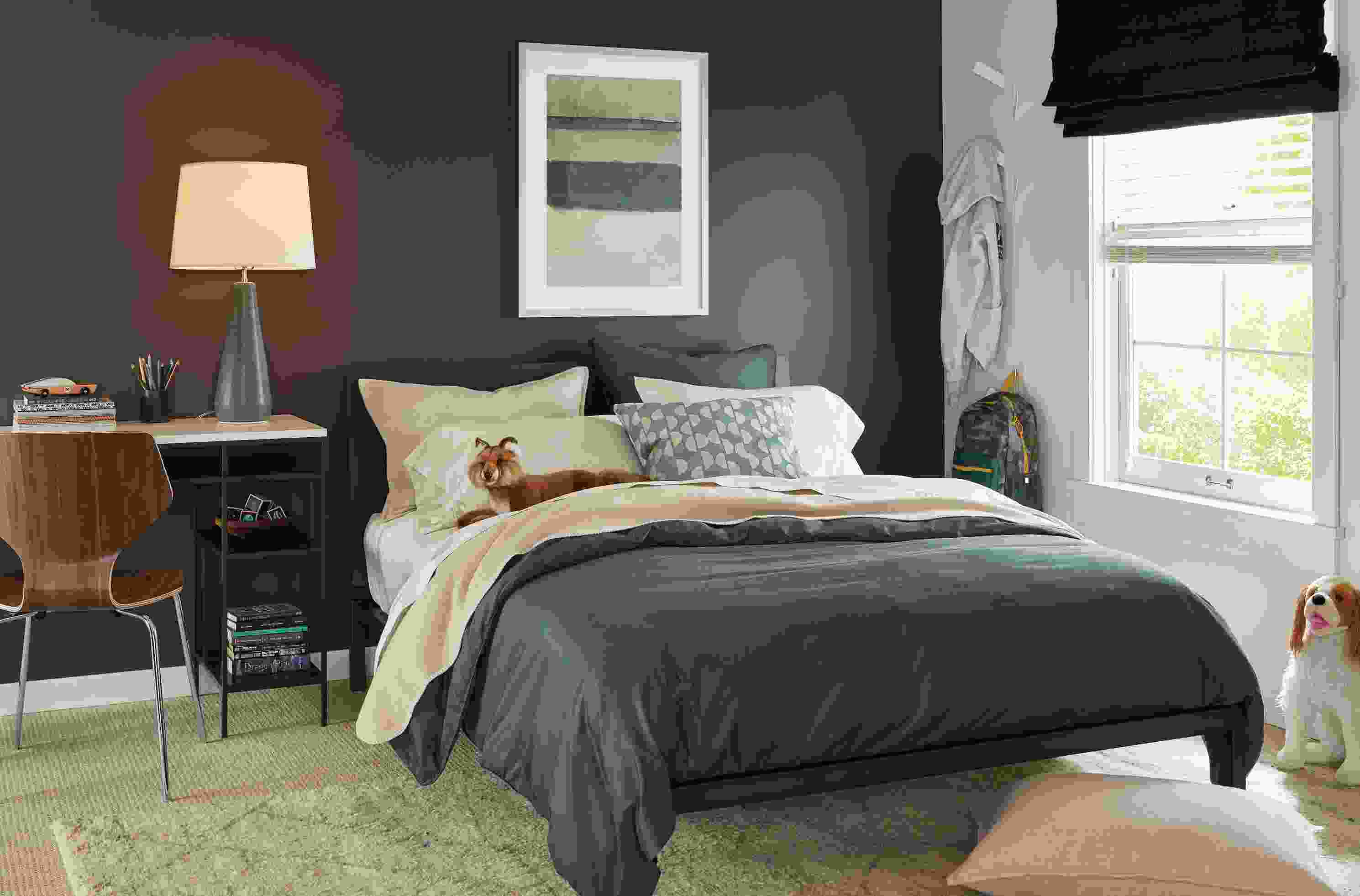 Bedroom with tailored sateen duvet cover in dark slate and sateen sheets in ecru.