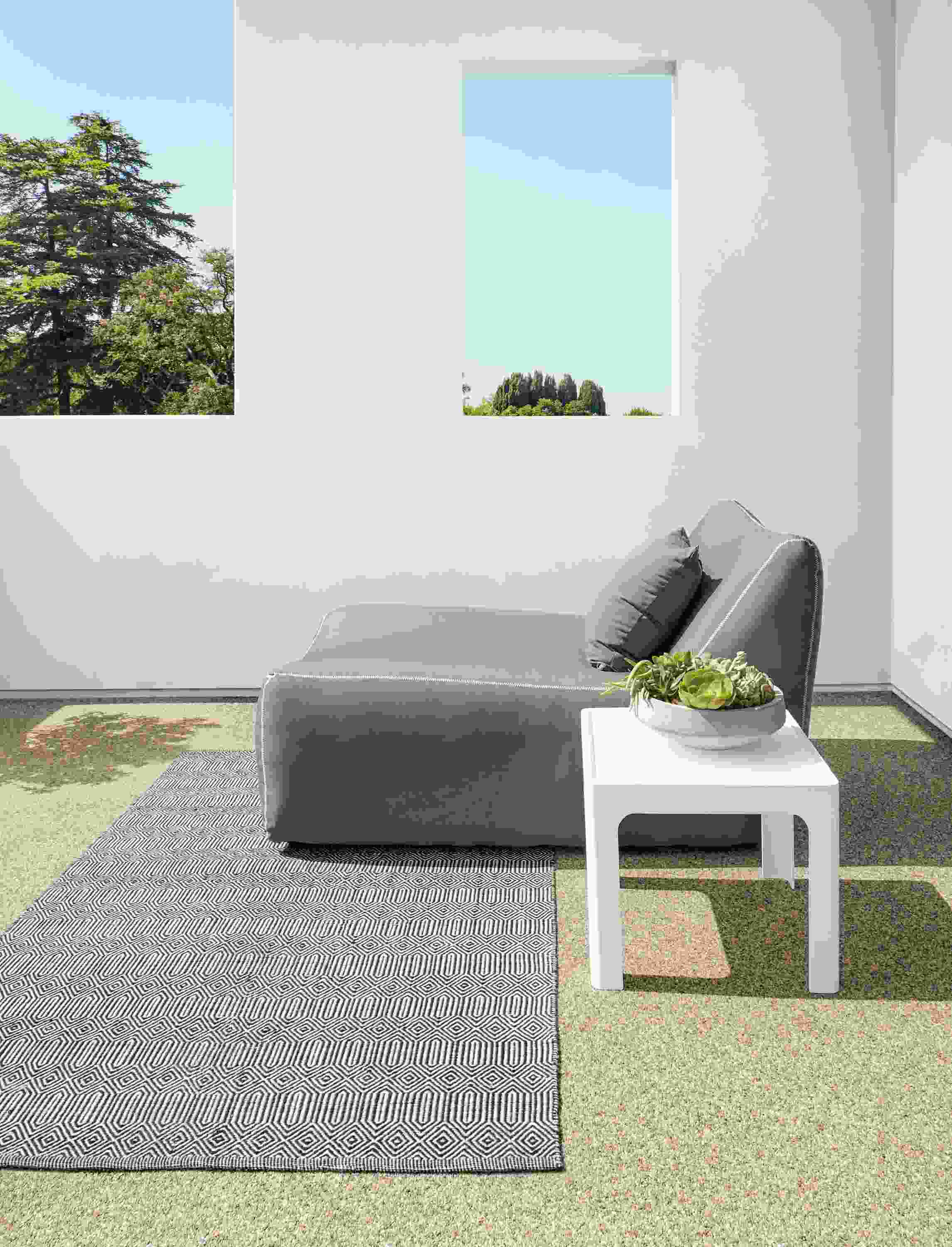 Outdoor space with Sequence rug in Ivory/Black and Maya chaise in Sunbrella Canvas Charcoal.