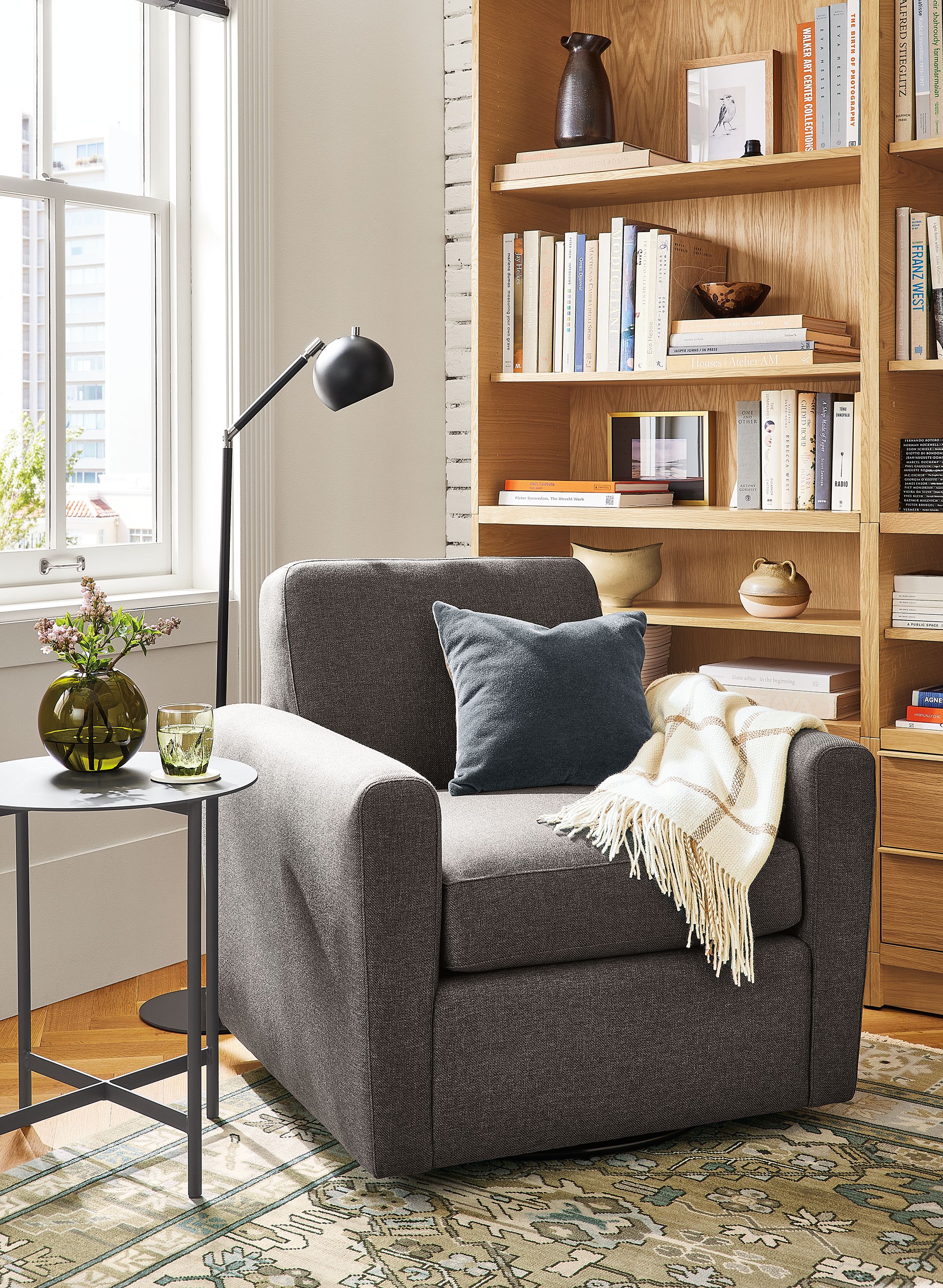 Living room with Seth swivel chair, Taylor bookcases, Camber floor lamp.