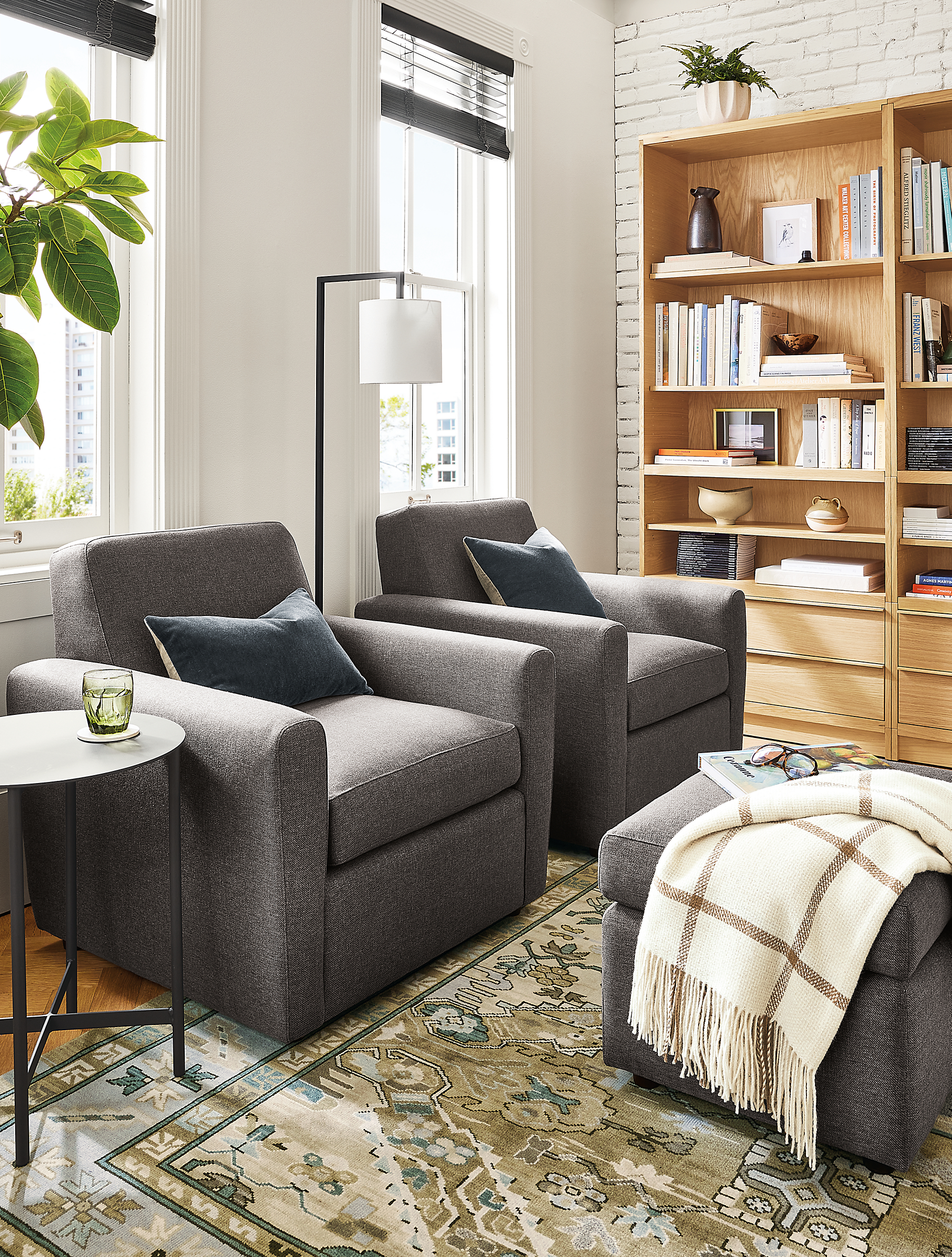 Living room with two Seth swivel chairs and Seth ottoman, Kayseri rug, Vincent throw.