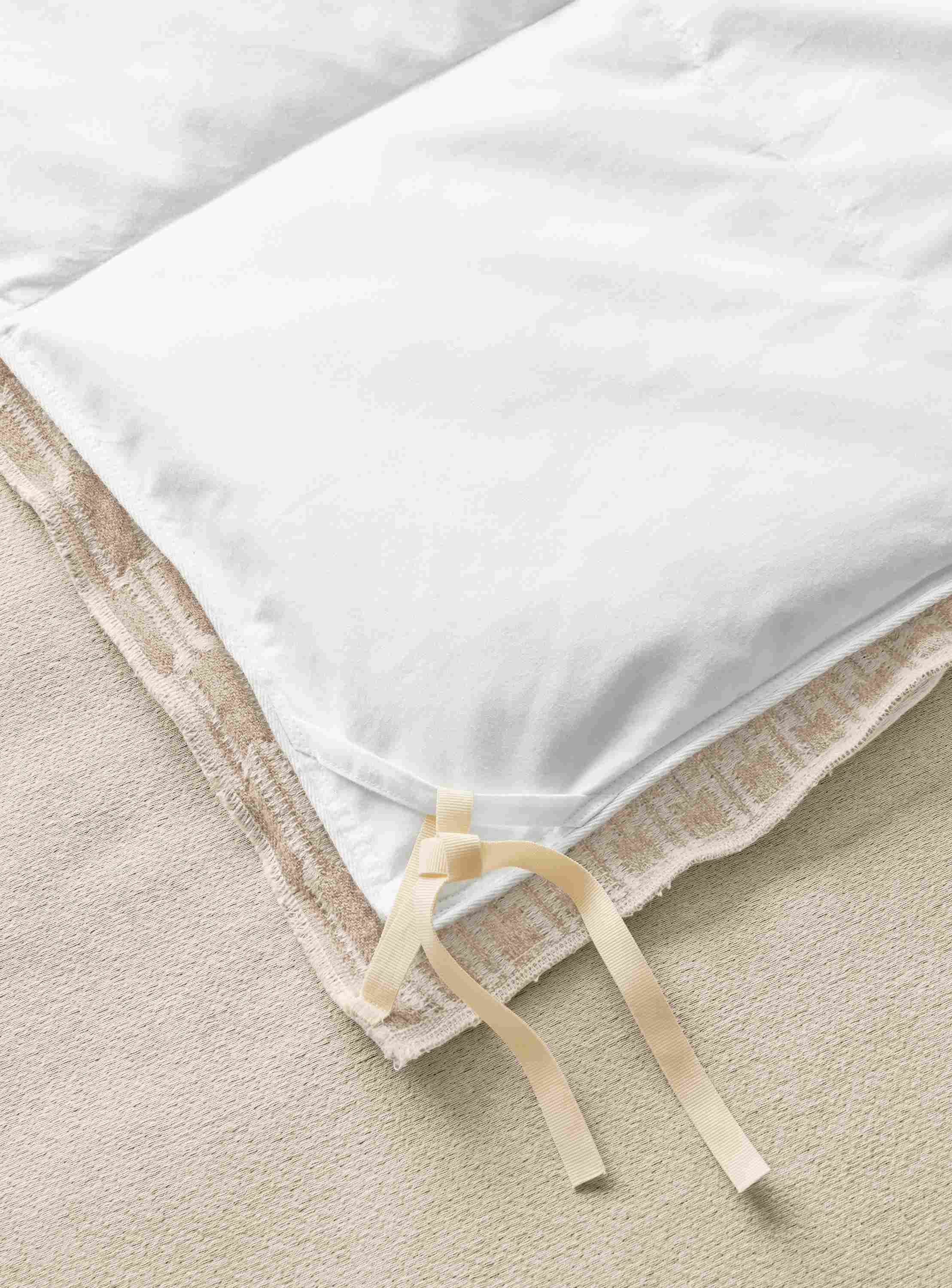 Close tie detail of queen Sheffield duvet cover in ivory.