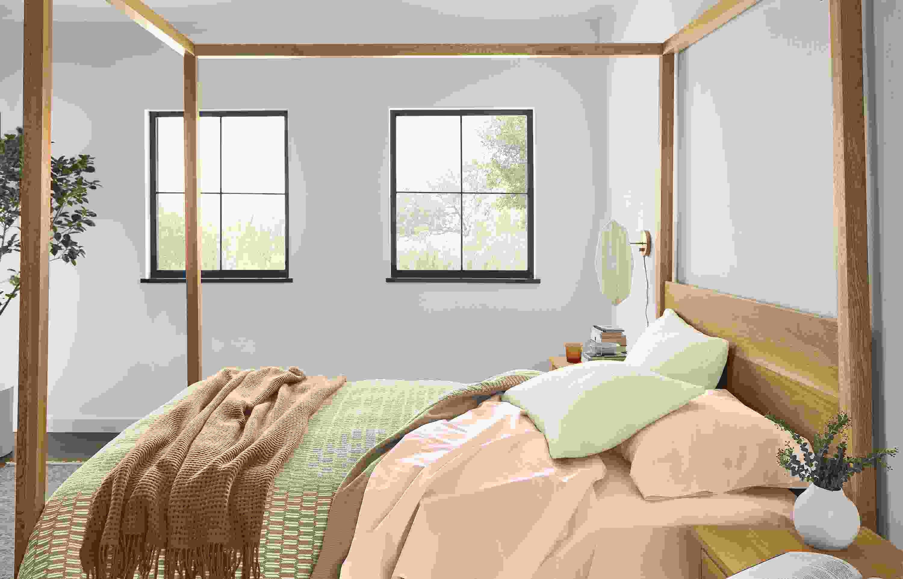 Bedroom with Hale queen canopy bed in white oak with Signature percale queen sheets in blush.