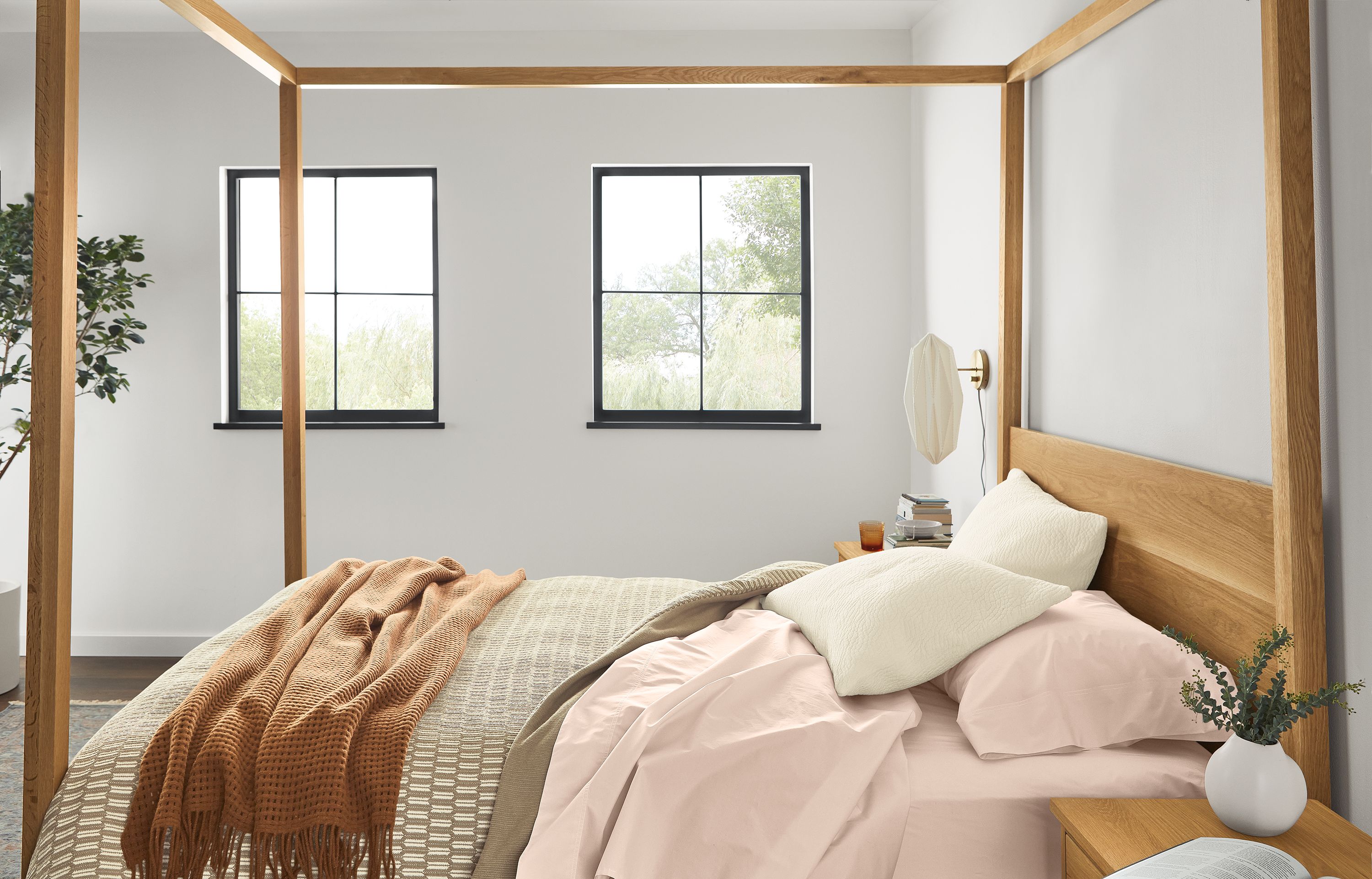 Bedroom with Hale queen canopy bed in white oak with Signature percale queen sheets in blush.
