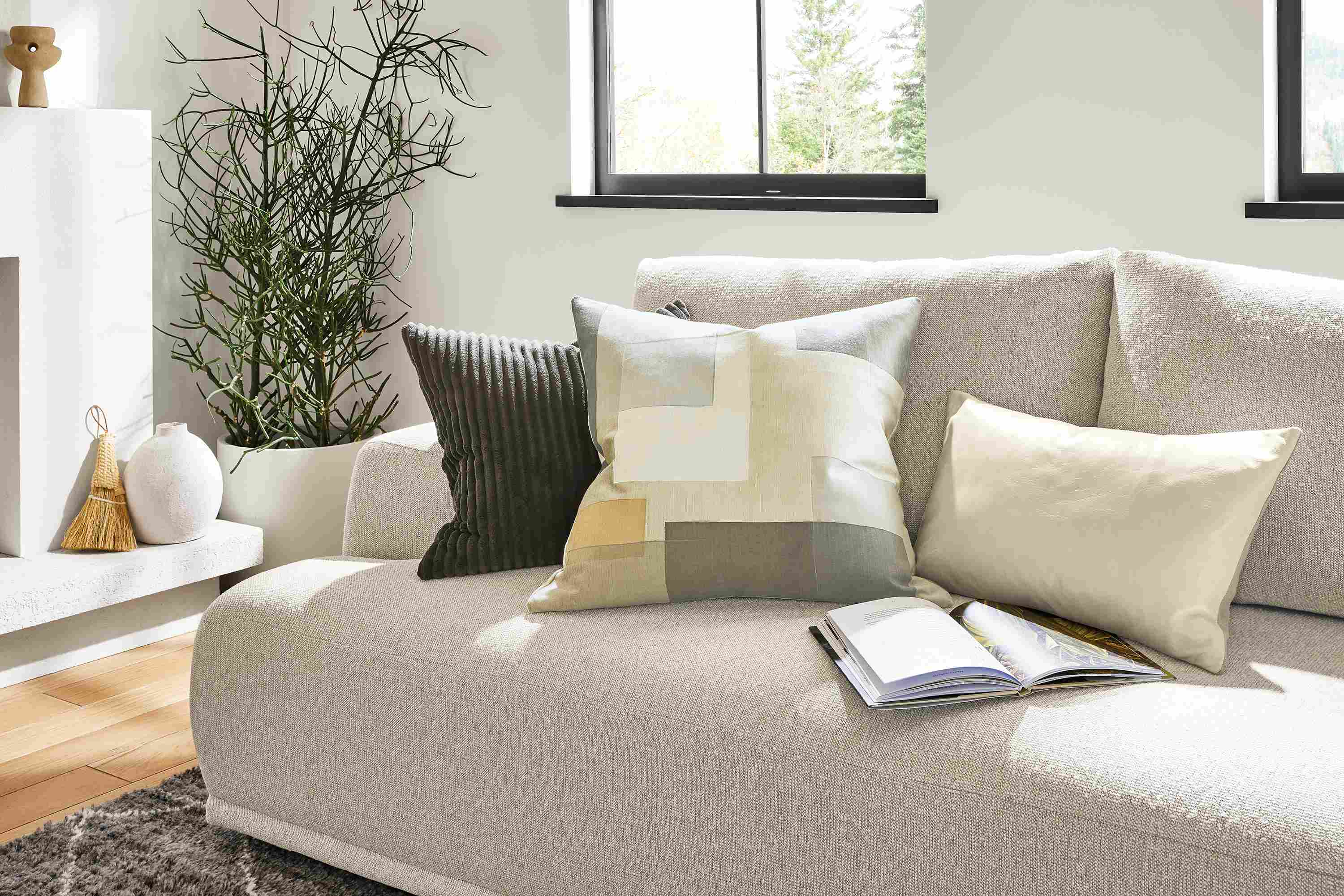 Shift, Gavin and Ewan throw pillows on Fia sectional sofa in a living room.