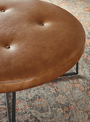 Detailed image of sidney round ottoman in vento cognac.