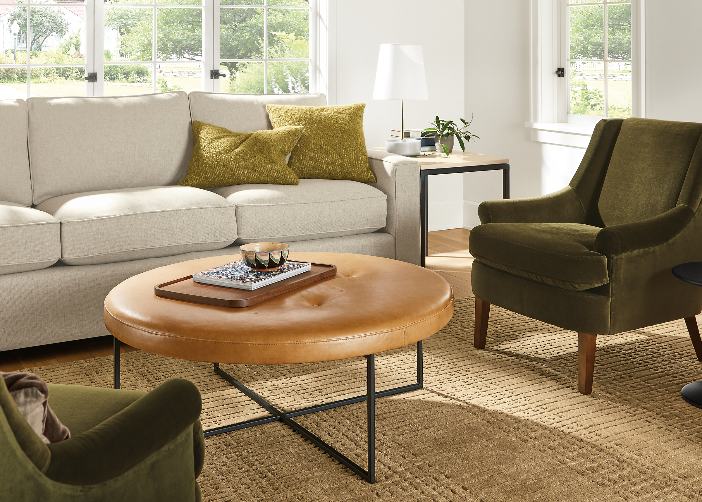 Living room with Sidney ottoman in leather, Louise chairs in Vance olive and York sofa in Sumner linen.