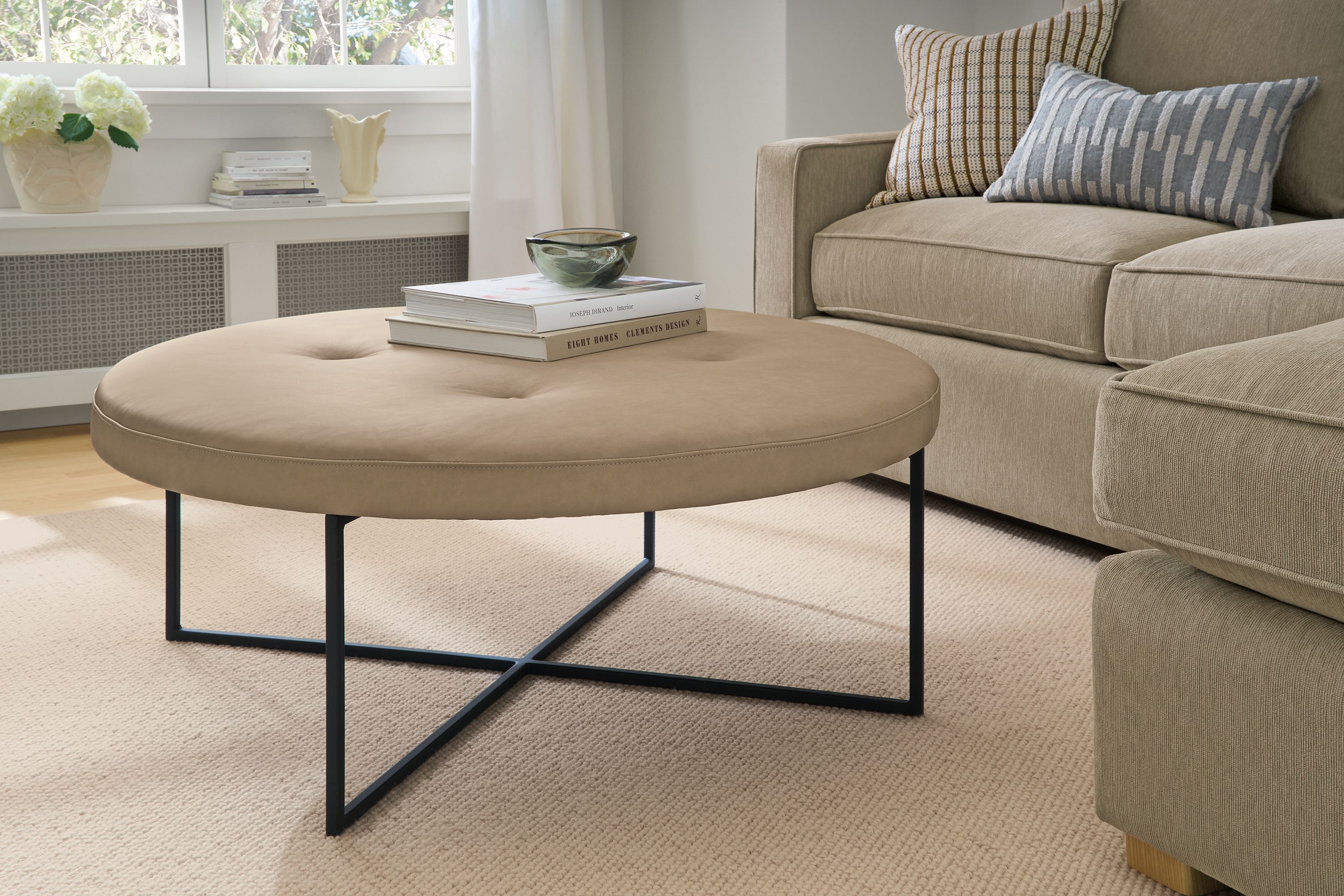 42" diam round ottoman in Laino putty leather with graphtie base