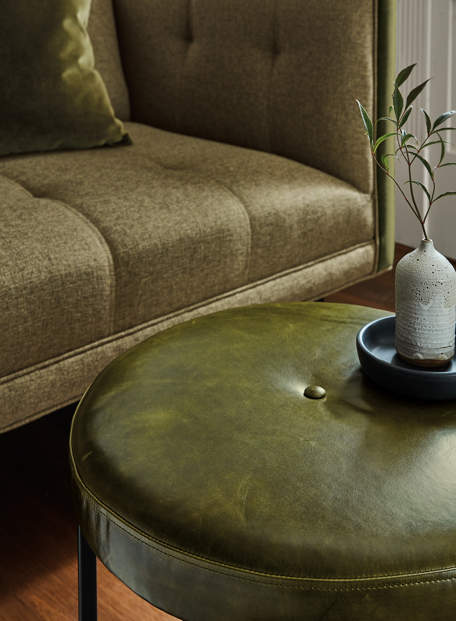 Detail of Sidney round ottoman in Vento Olive leather.