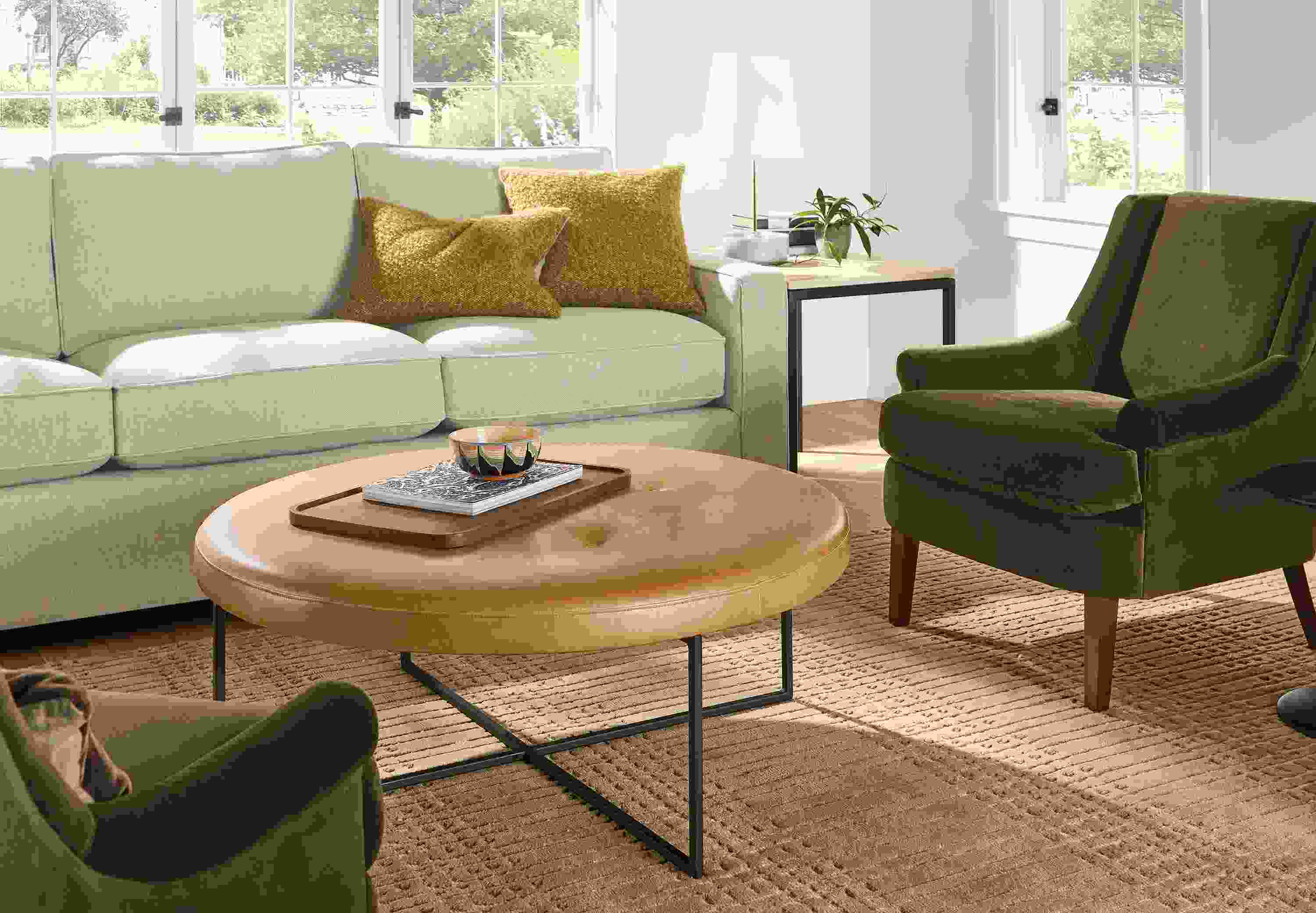 Living room with Sidney ottoman in Palermo Camel leather and York sofa in Sumner Linen.