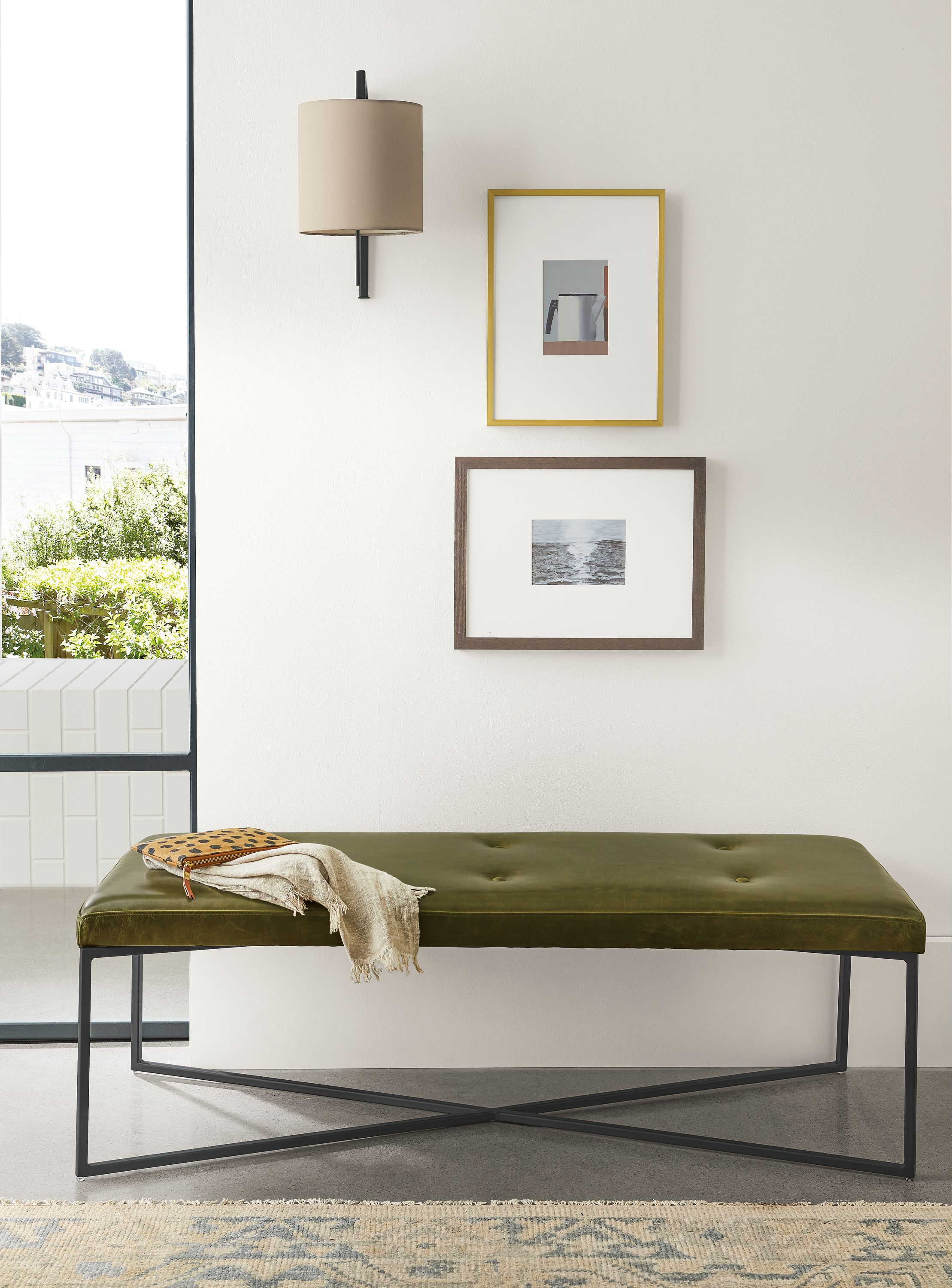 Detail of rectangular Sidney ottoman in Vento Olive leather in entryway.