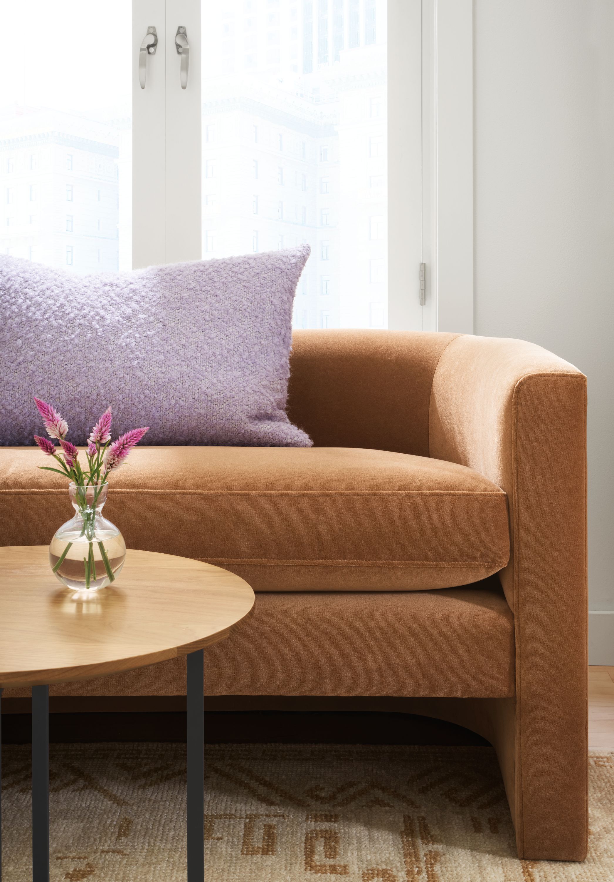 Detail image of silva 76-inch bench in banks cognac with classic round end table.