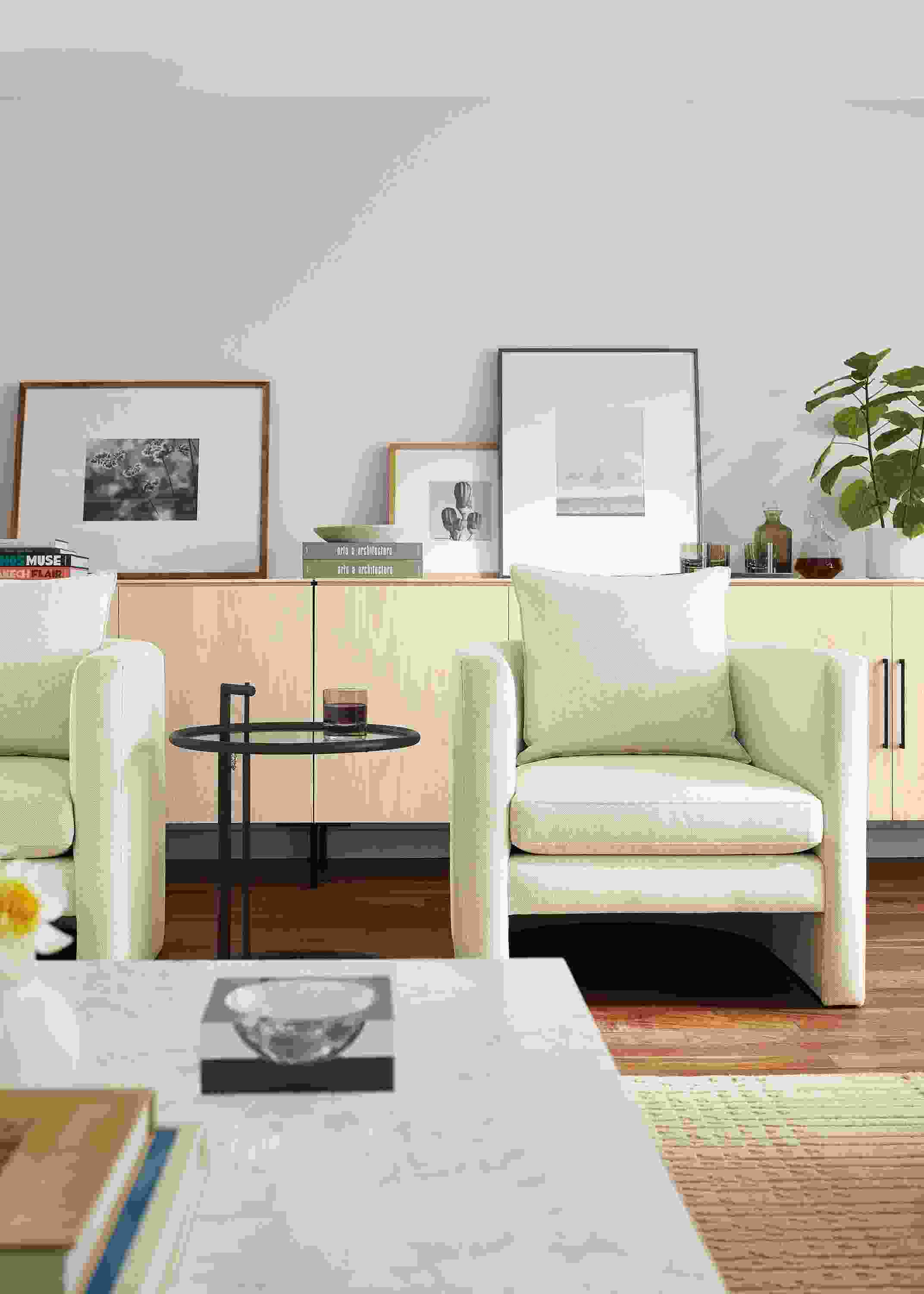 Living room with 2 Silva chairs in Sumner Ivory and 3 Kenwood storage cabinets in sand on ash.