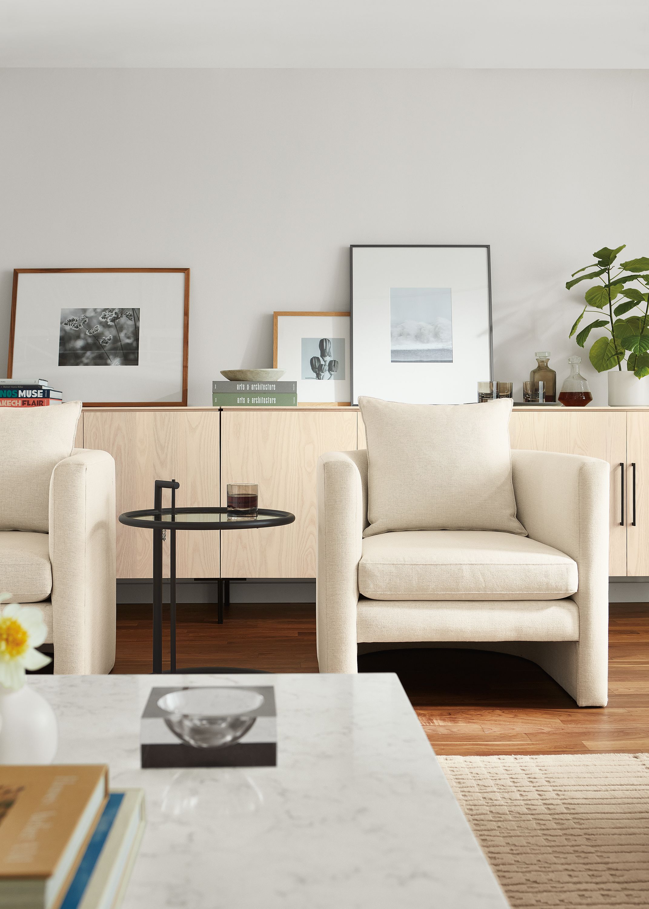 Living room with 2 Silva chairs in Sumner Ivory and 3 Kenwood storage cabinets in sand on ash.