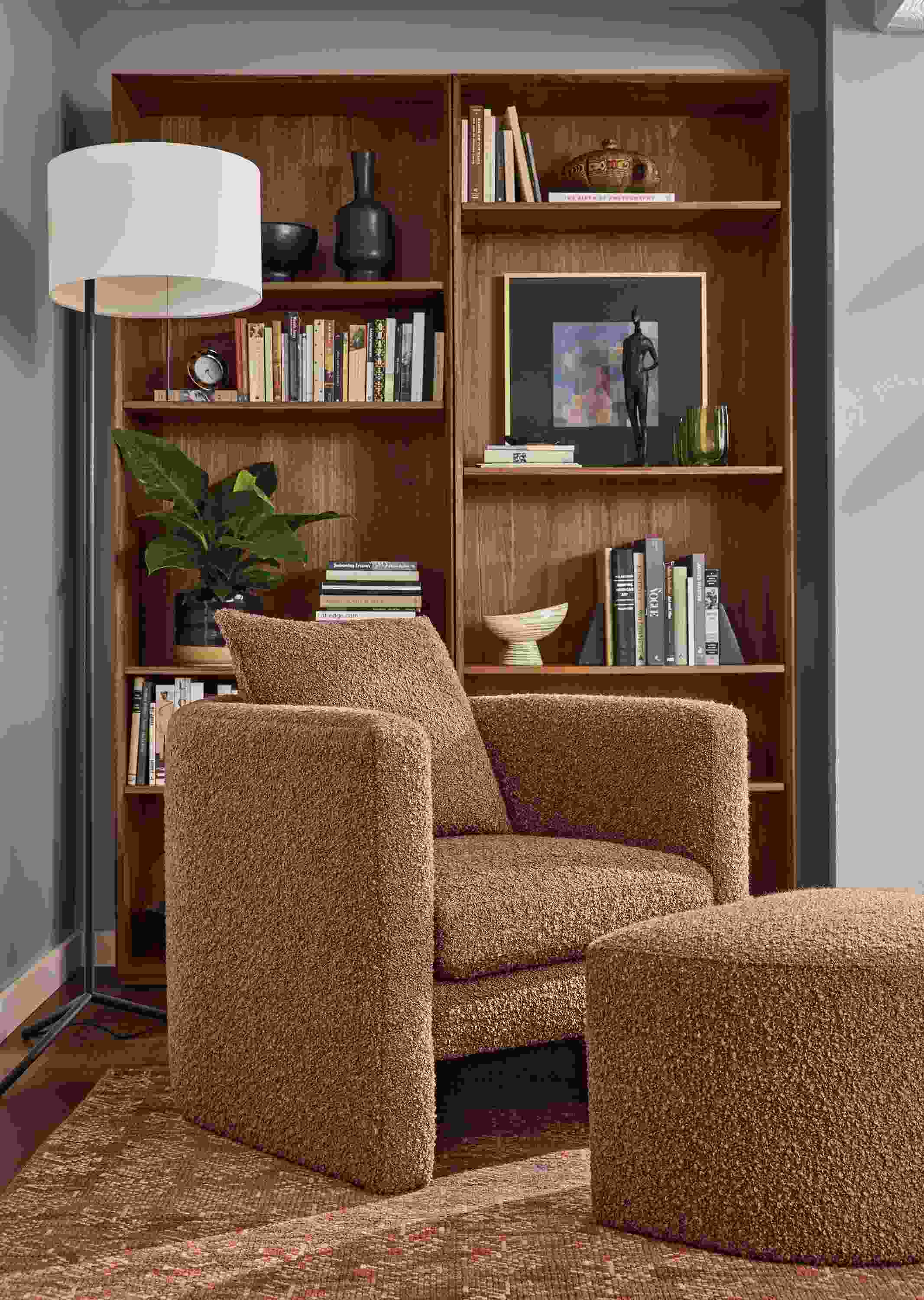 Living room with Silva chair and ottoman in Dornick Claystone, Layla rug in brick and Crane floor lamp in graphite.