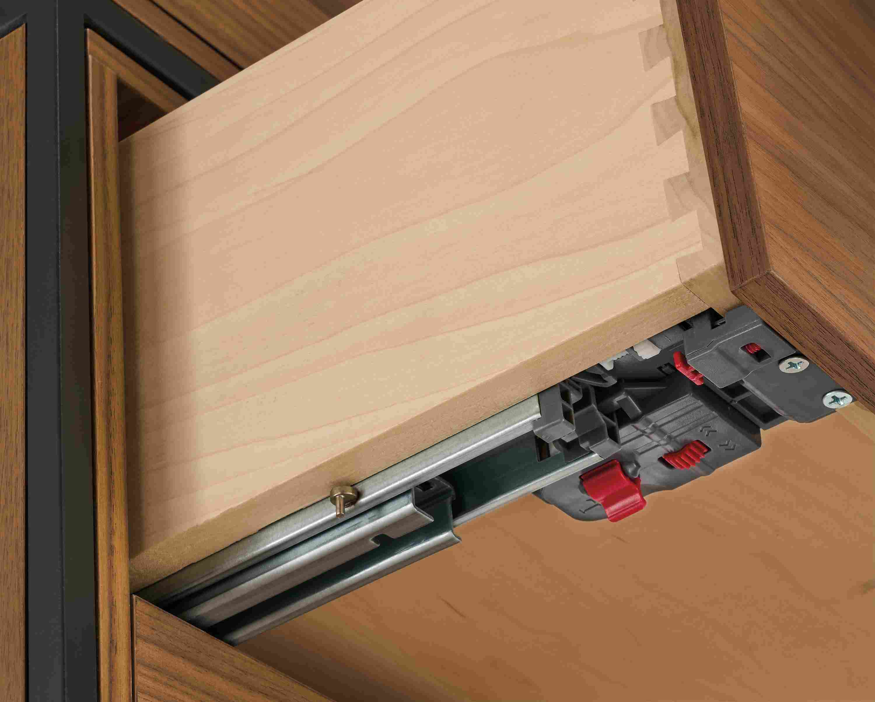 Detail of drawer slide and soft-close adjustment on Slim 4-door insert bookcase in walnut and natural steel.
