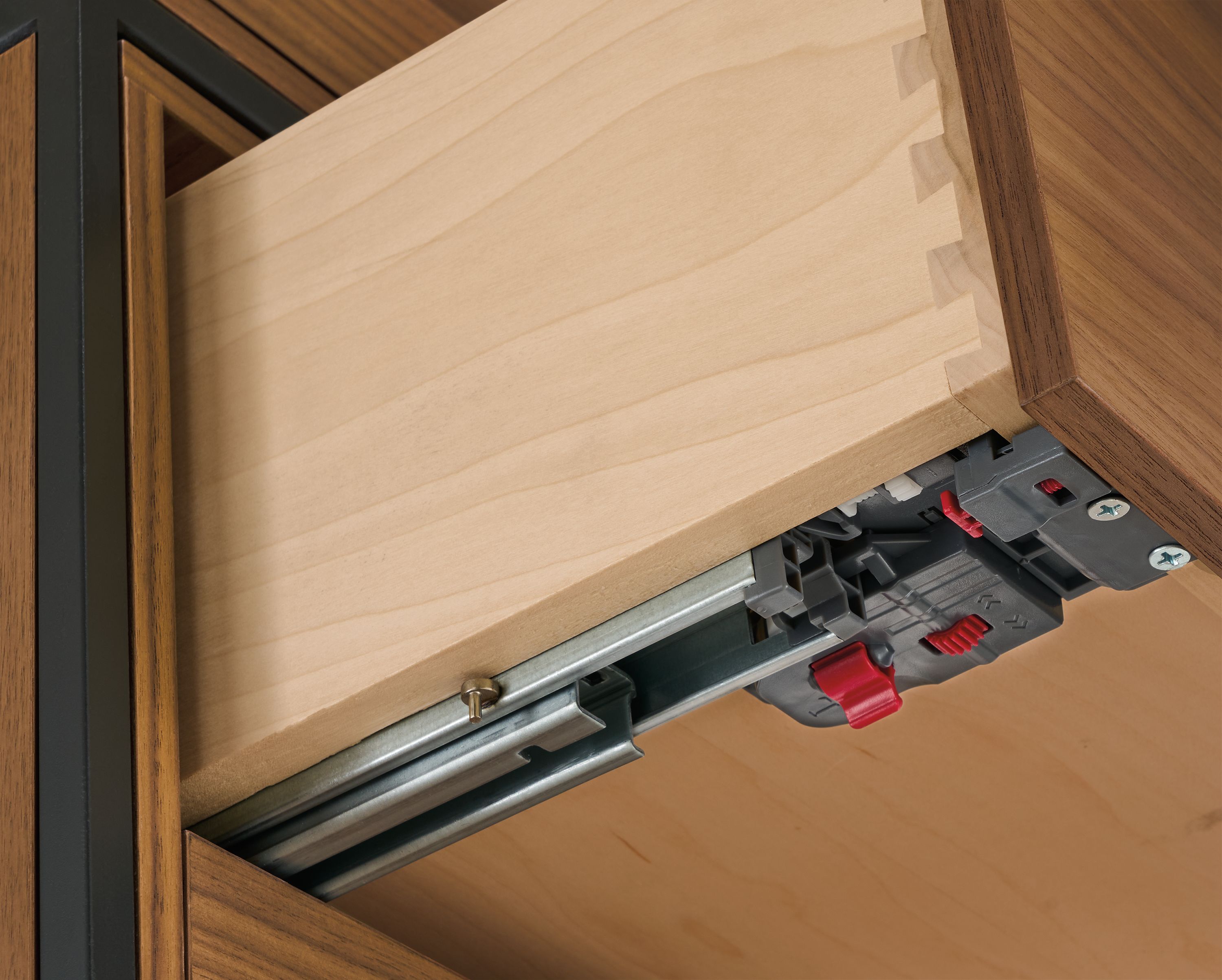 Detail of drawer slide and soft-close adjustment on Slim 4-door insert bookcase in walnut and natural steel.