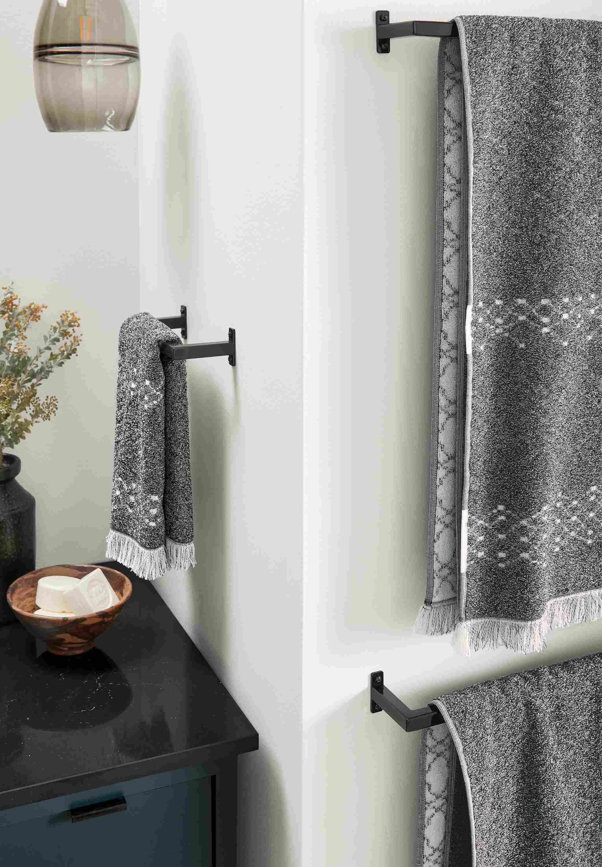 detail of slim towel racks with path towels in bathroom