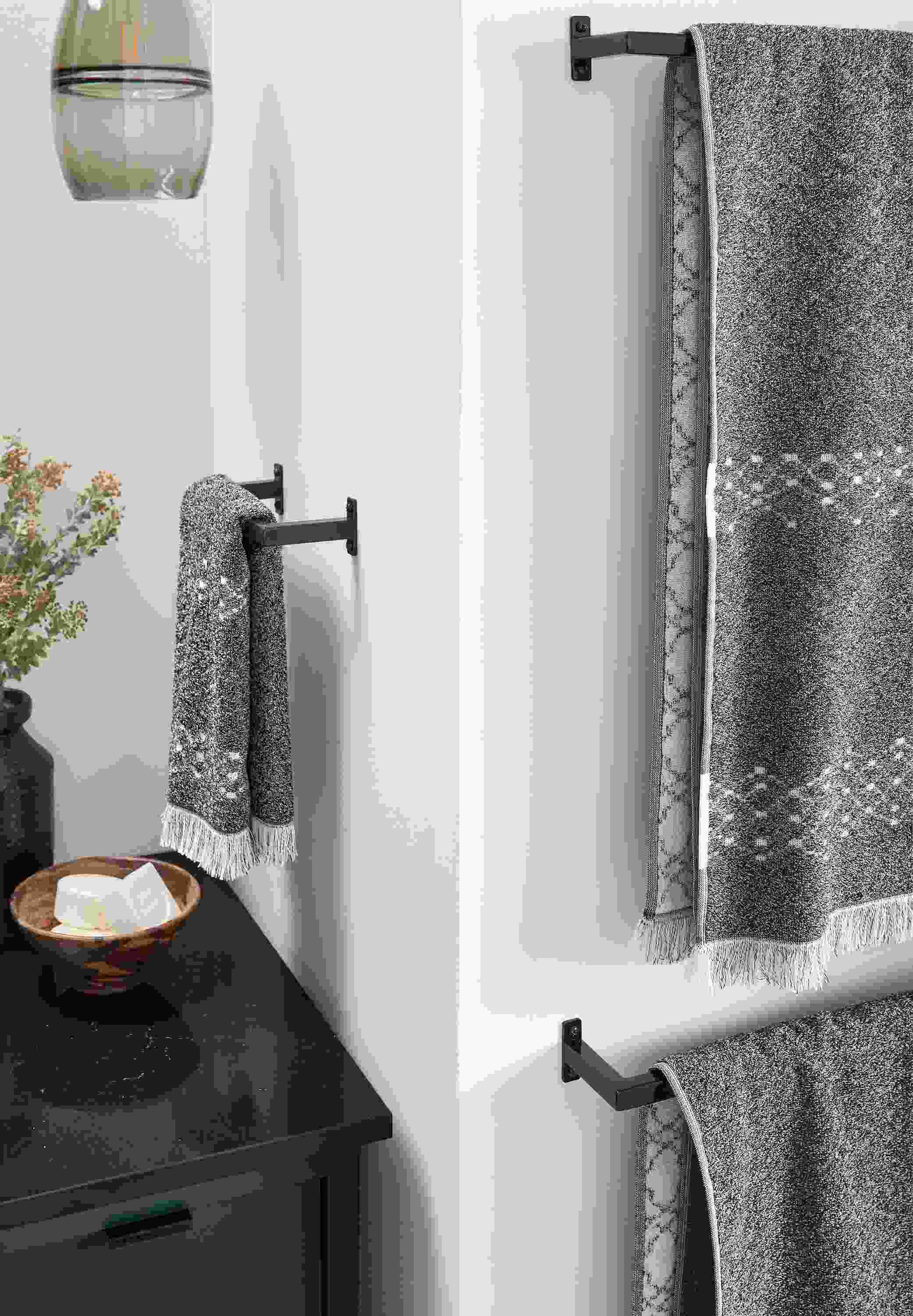detail of slim towel racks with path towels in bathroom