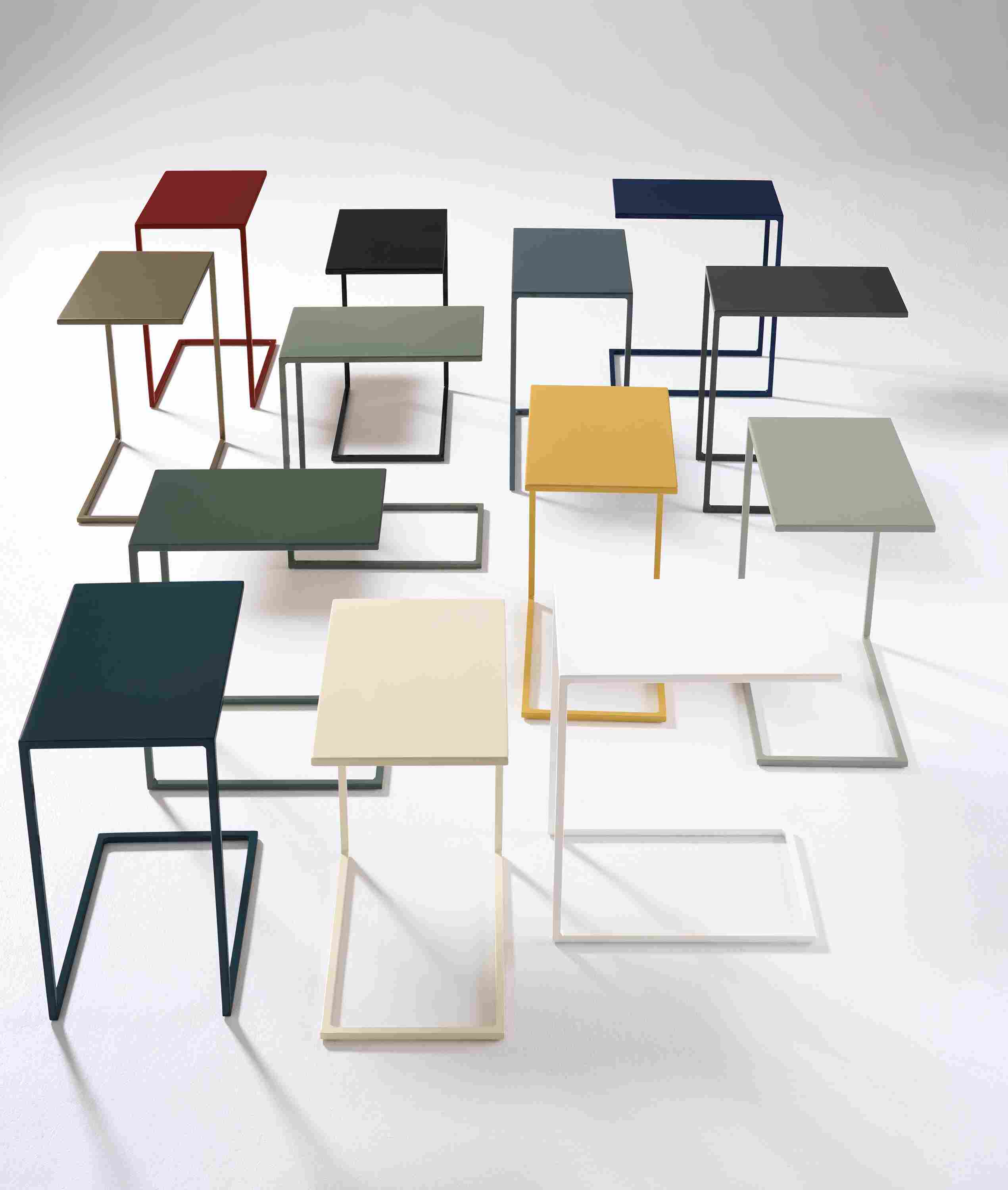 A group of Slim 13-wide C-shaped tables in various color options.