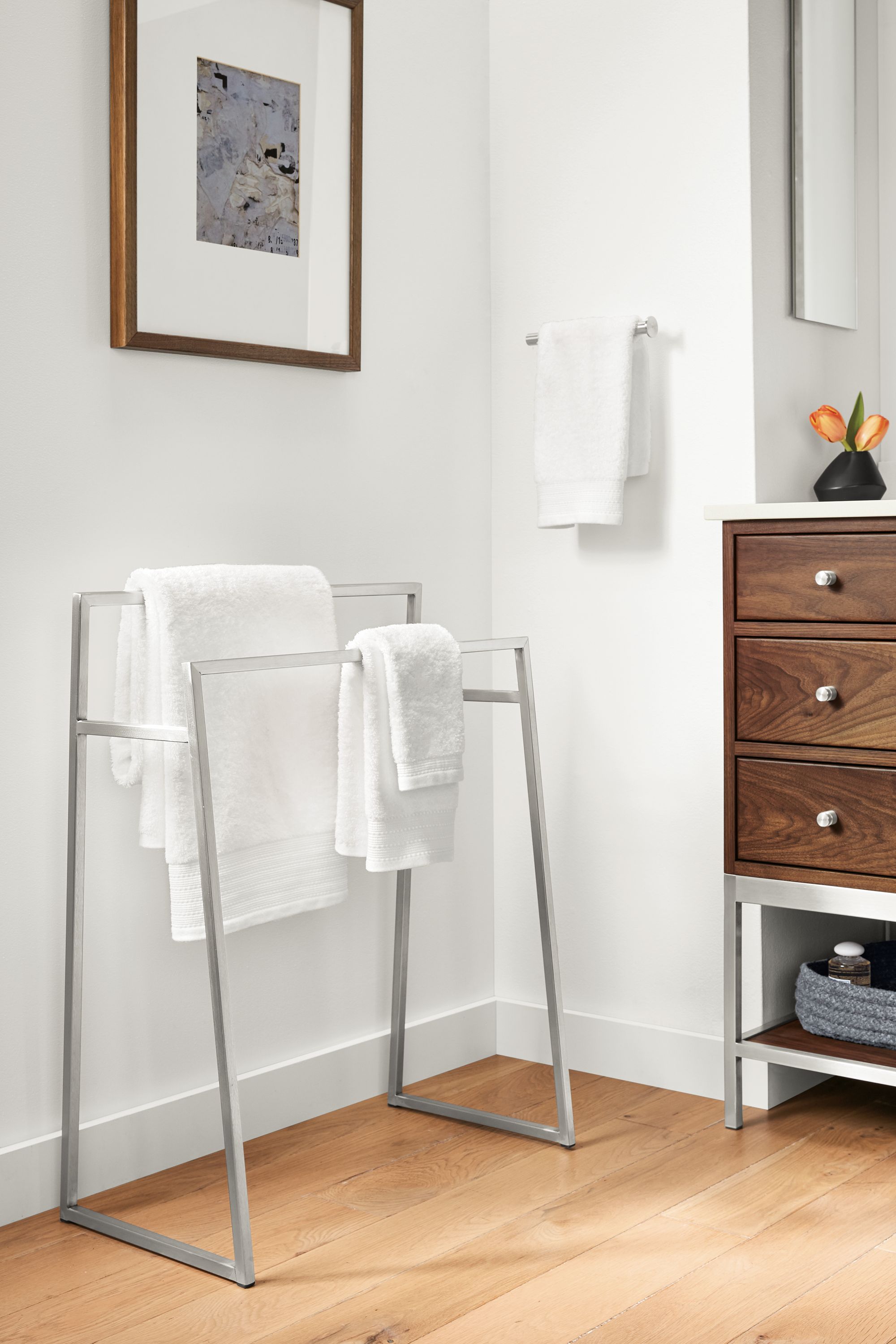 Detail of Slim freestanding towel rack in stainless steel in bathroom.