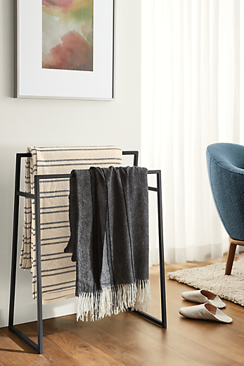 Detail of Slim freestanding towel rack in graphite in living room.