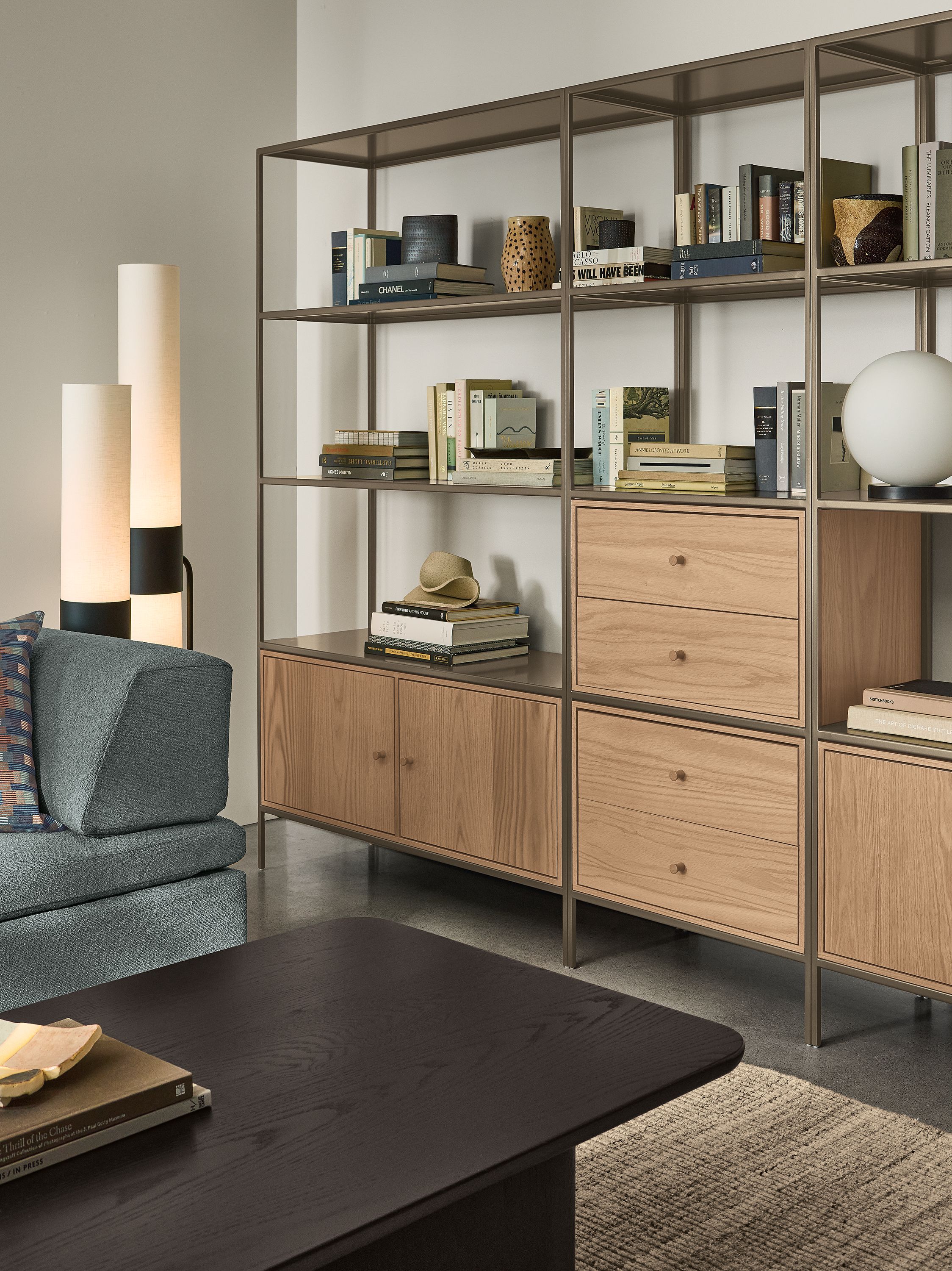 Living room with 3 Slim bookcases in mineral with rye on red oak inserts and miranda daybed in declan haze.