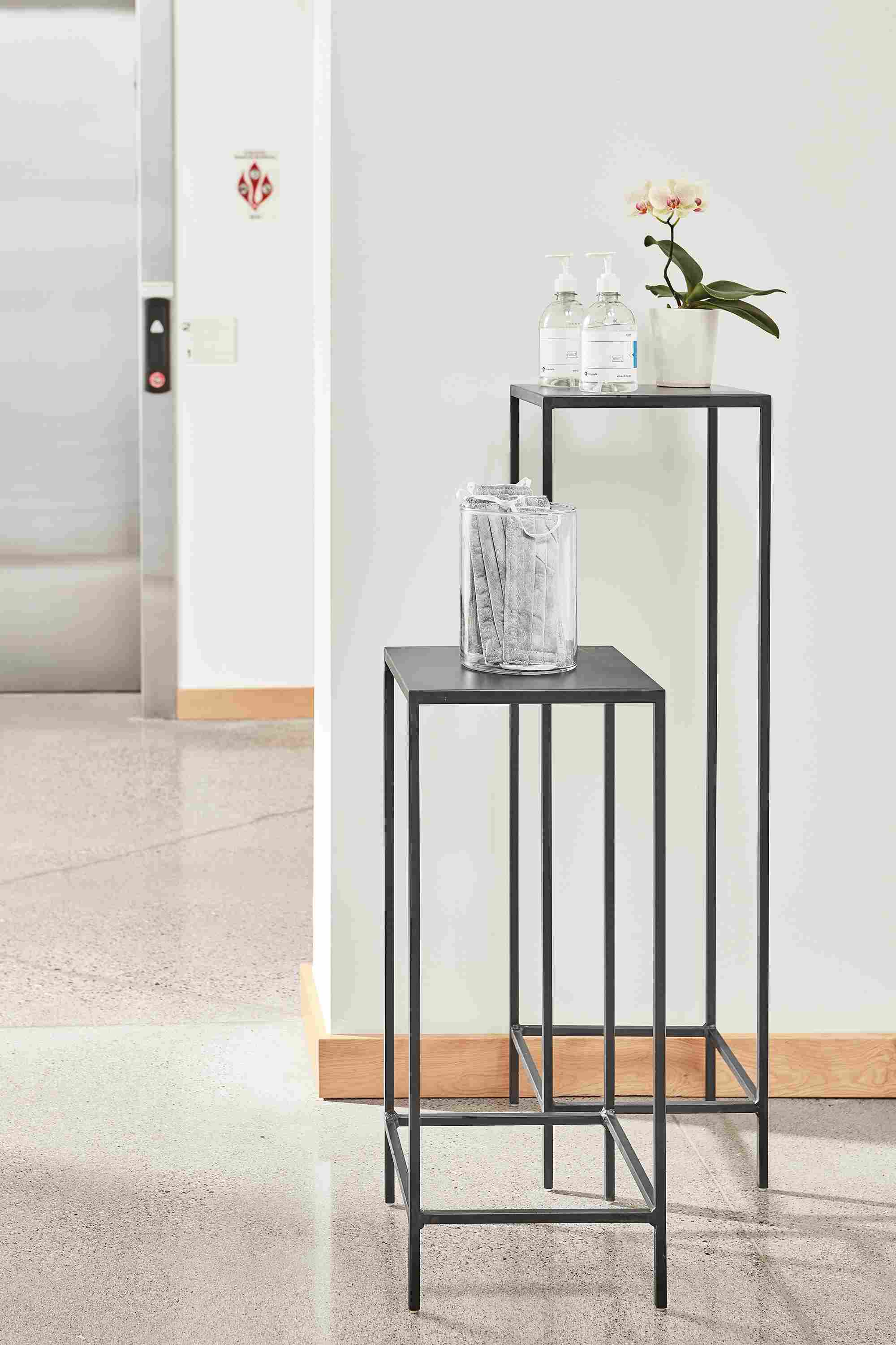Detailed image of slim 12-by-12 end table in natural steel.