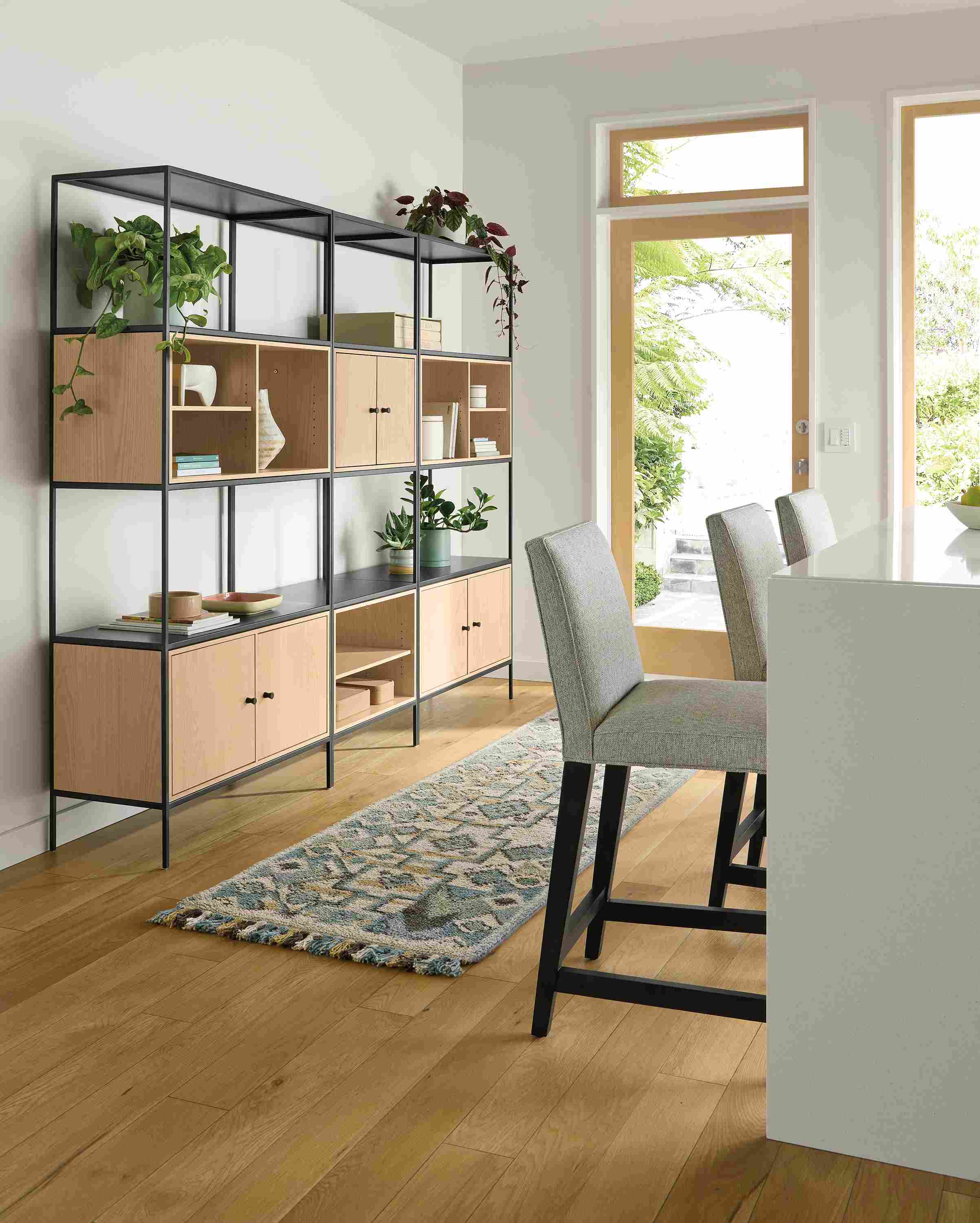 Kitchen seating area with slim 92-wide six-insert wall unit in salt on red oak and ona runner in ocean.