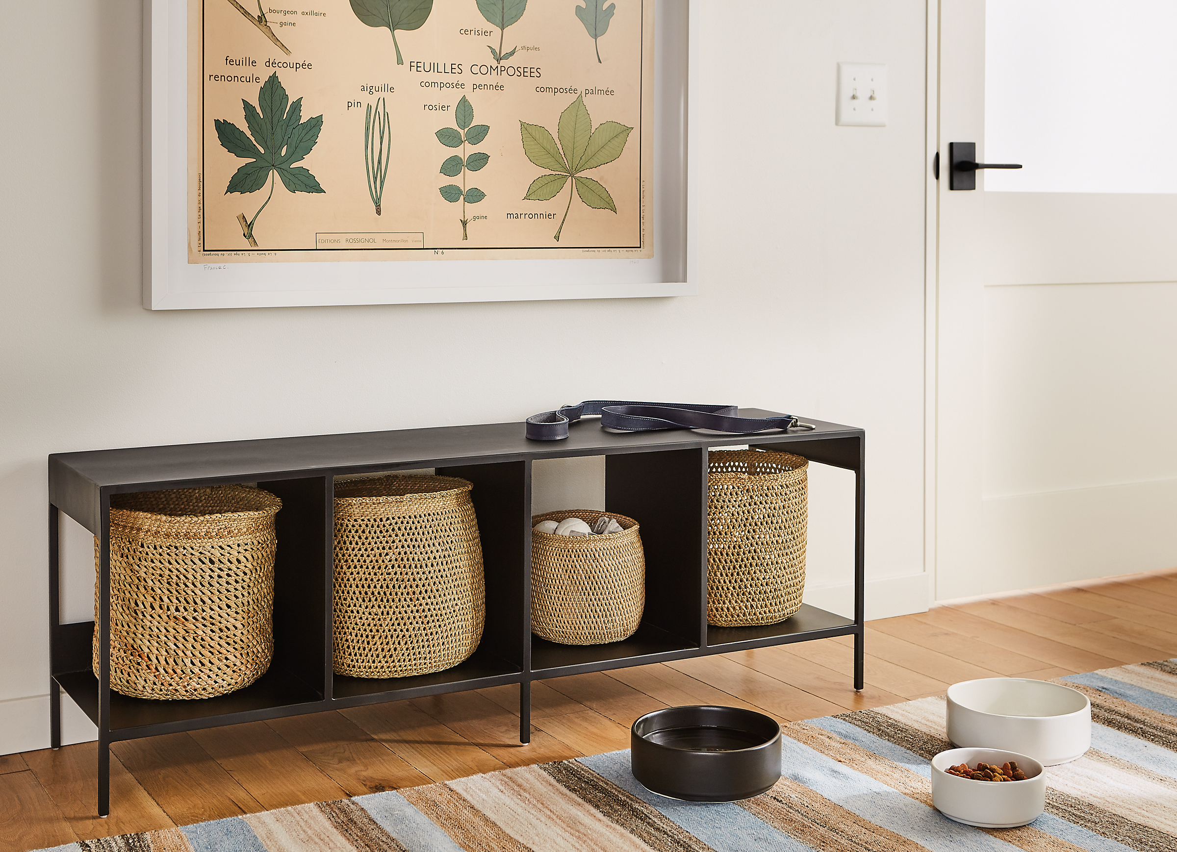 Entryway setting with slim 52-wide cubby bench in natural steel with iringa baskets in natural.
