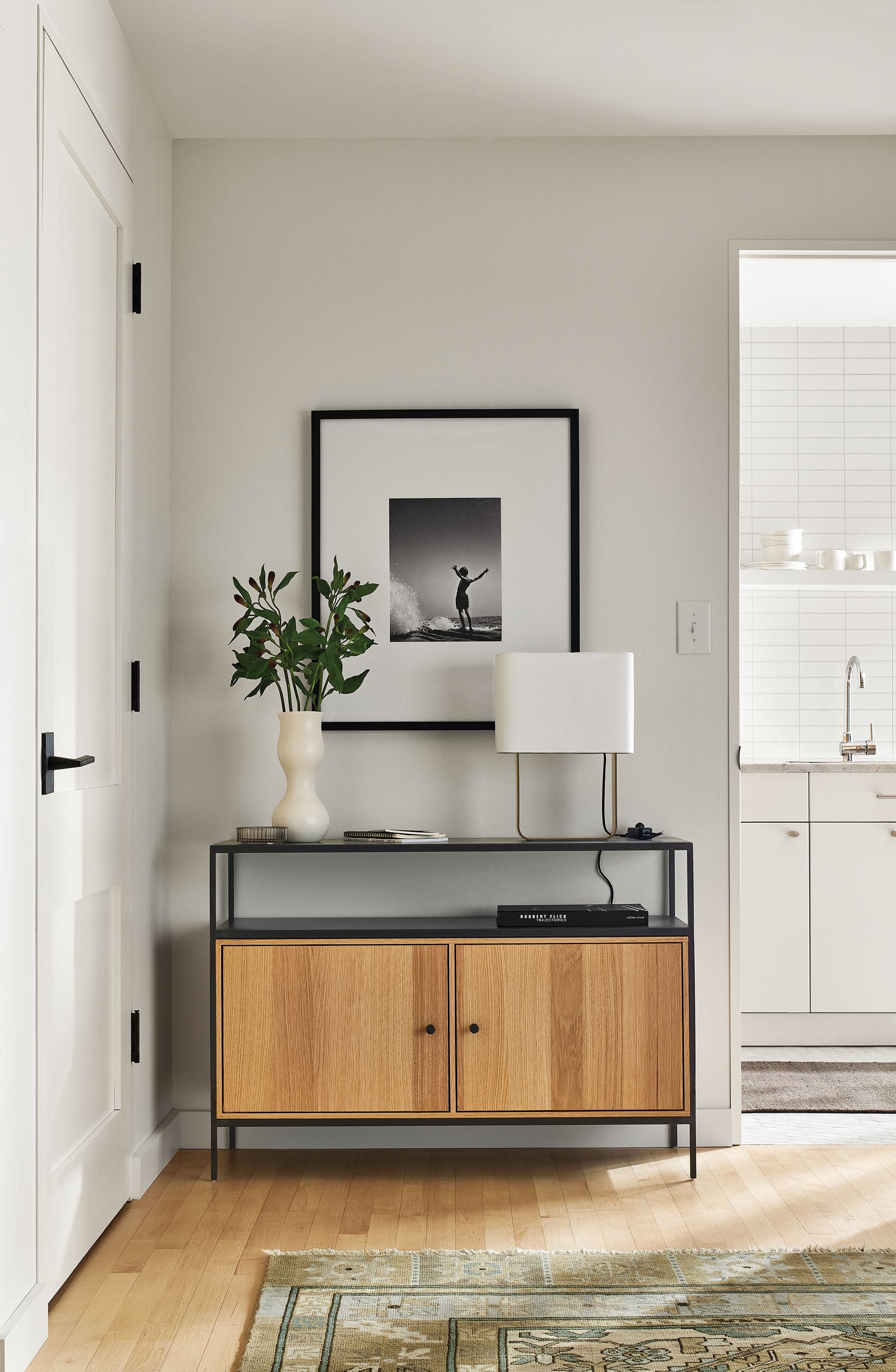 entryway with slim console bookcase with double door insert.