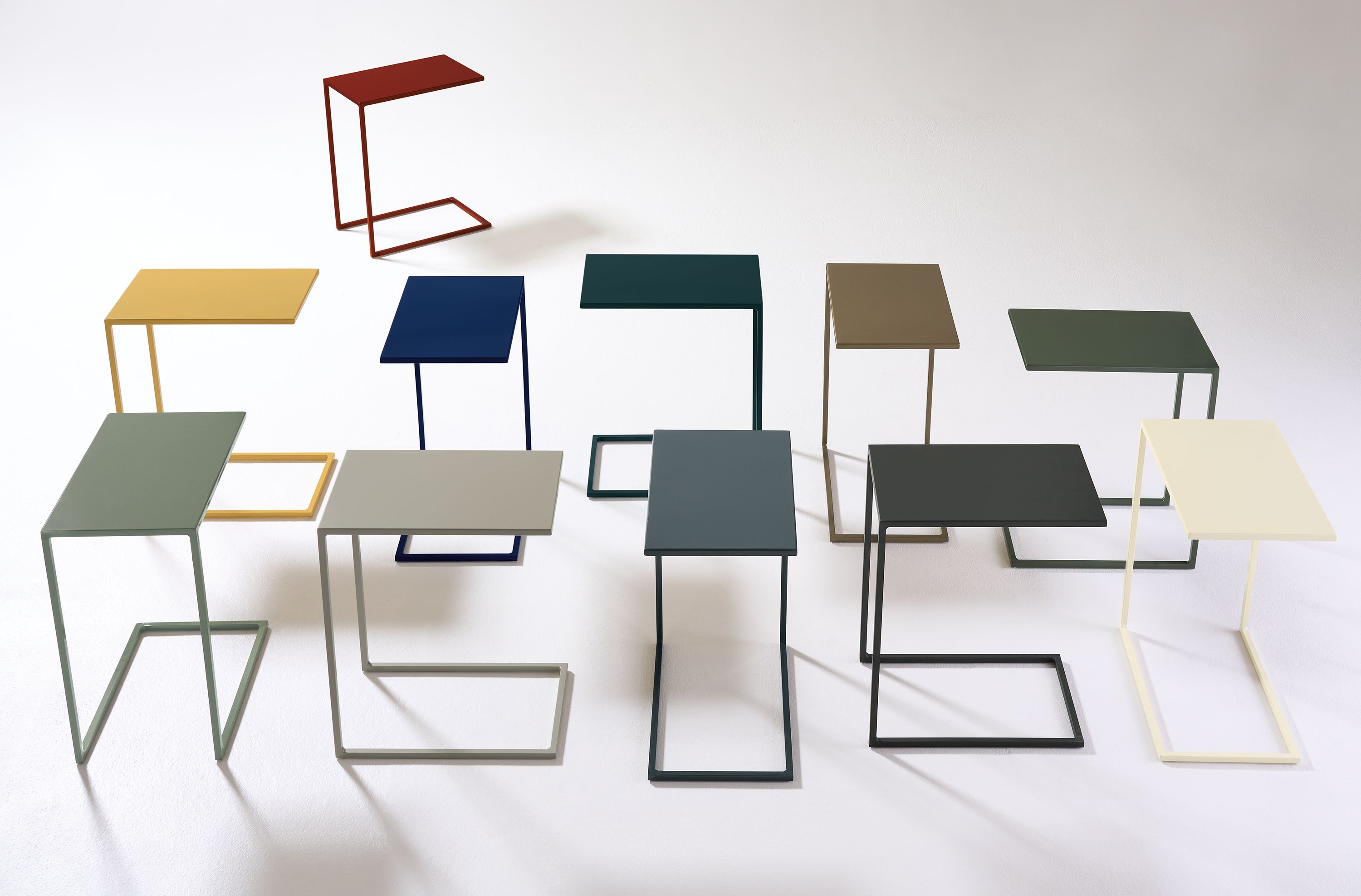 Slim 13-wide C-shaped tables in a group showing various color options.