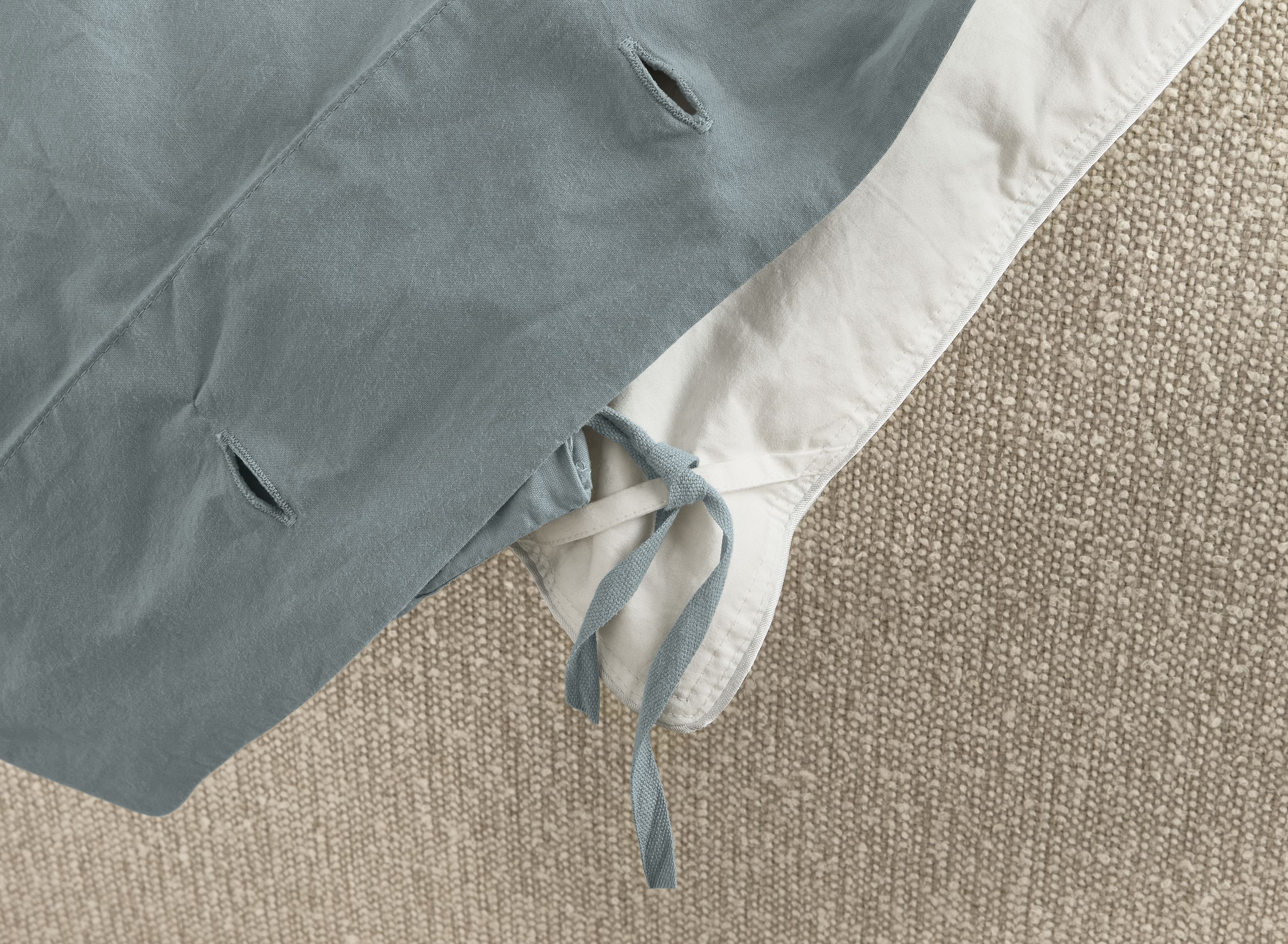 Detail of corner ties on soft-washed percale full/queen duvet set in lake colorway.