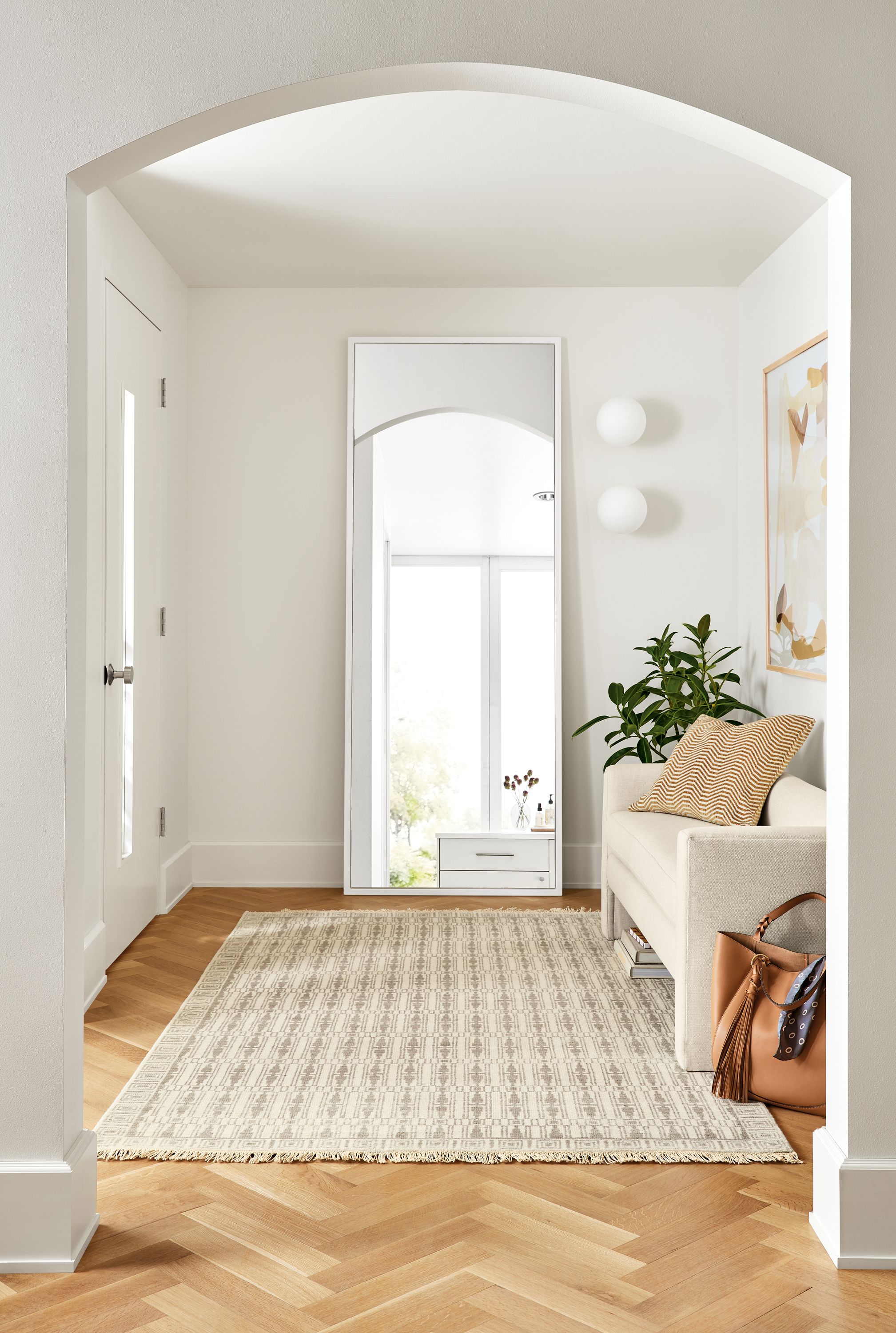 detail of soho floor mirror in entryway with silva bench