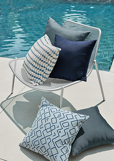 Soleiel outdoor lounge chair in silver with outdoor pillows.