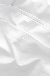 Button detail of Sommerville percale bedding in white.