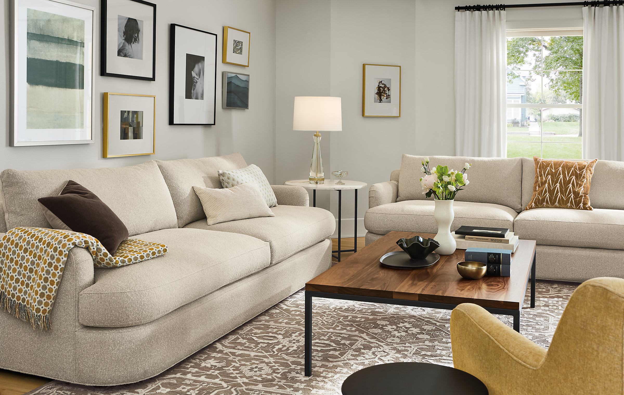 living room with two sonja sofas, lily chair, parsons coffee table, vanya rug, gatsby table lamp.