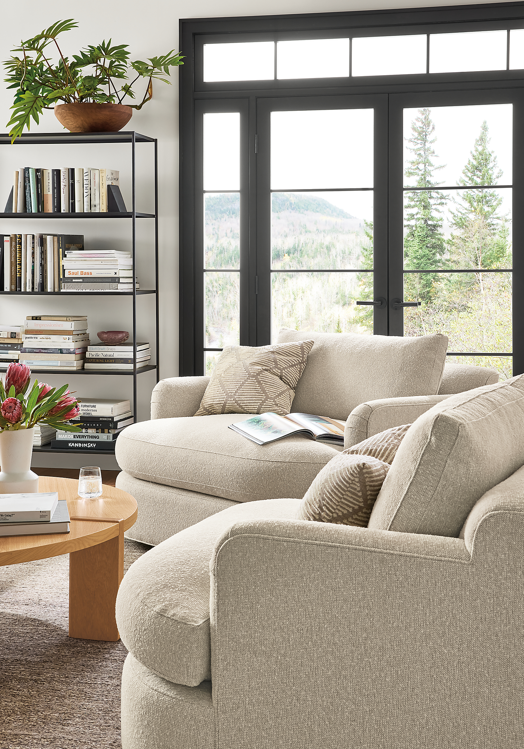 living room with Sonja Swivel Chairs in Conley Natural fabric and Hugh throw pillows in beige.