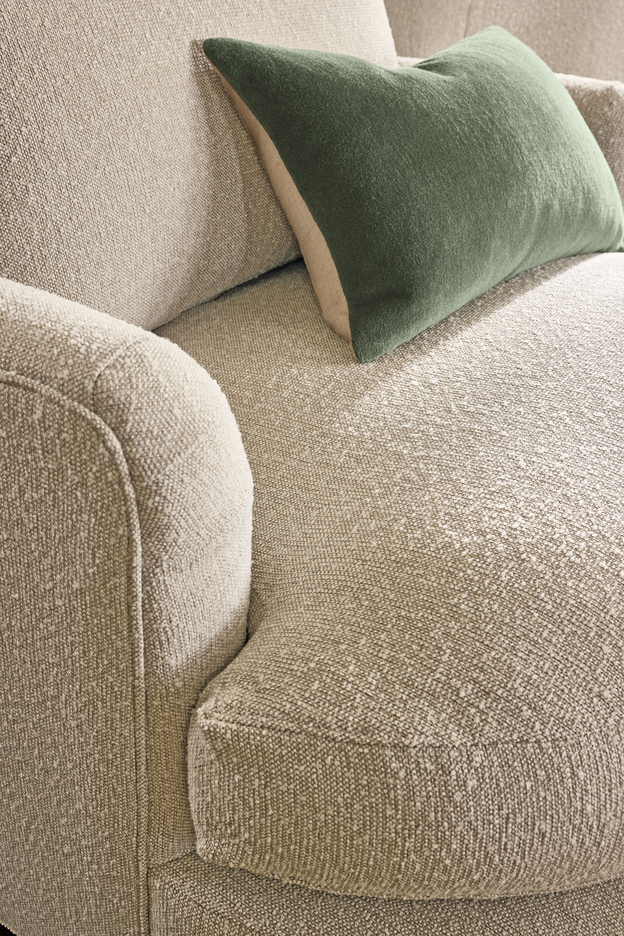 Detail of Sonja 40-wide Swivel chair in conley natural and Wool Velvet pillow in Olive.