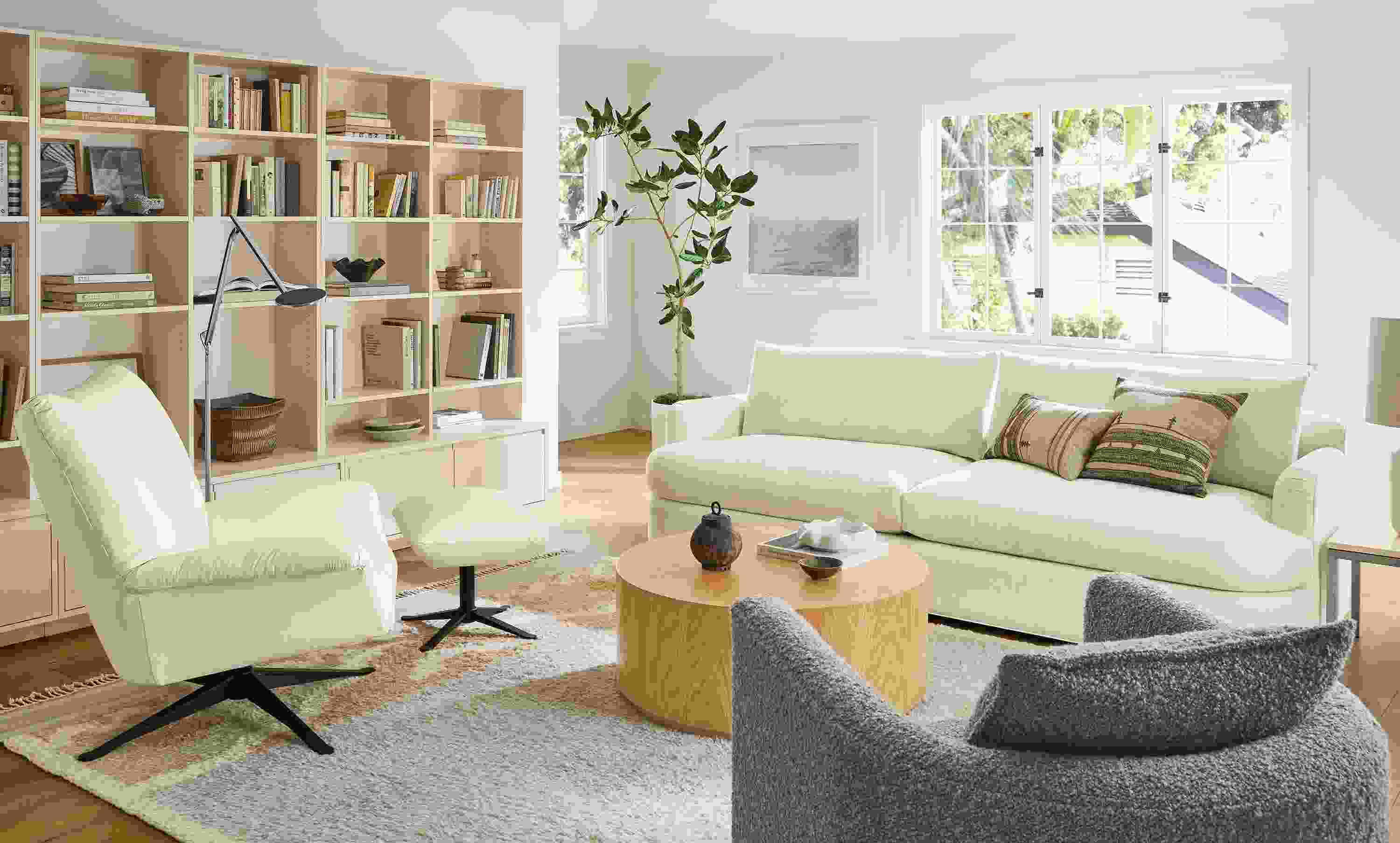 Living room with sonja sofa in hawkins ivory and paris swivel chair and ottoman in pesaro ivory with tova rug.