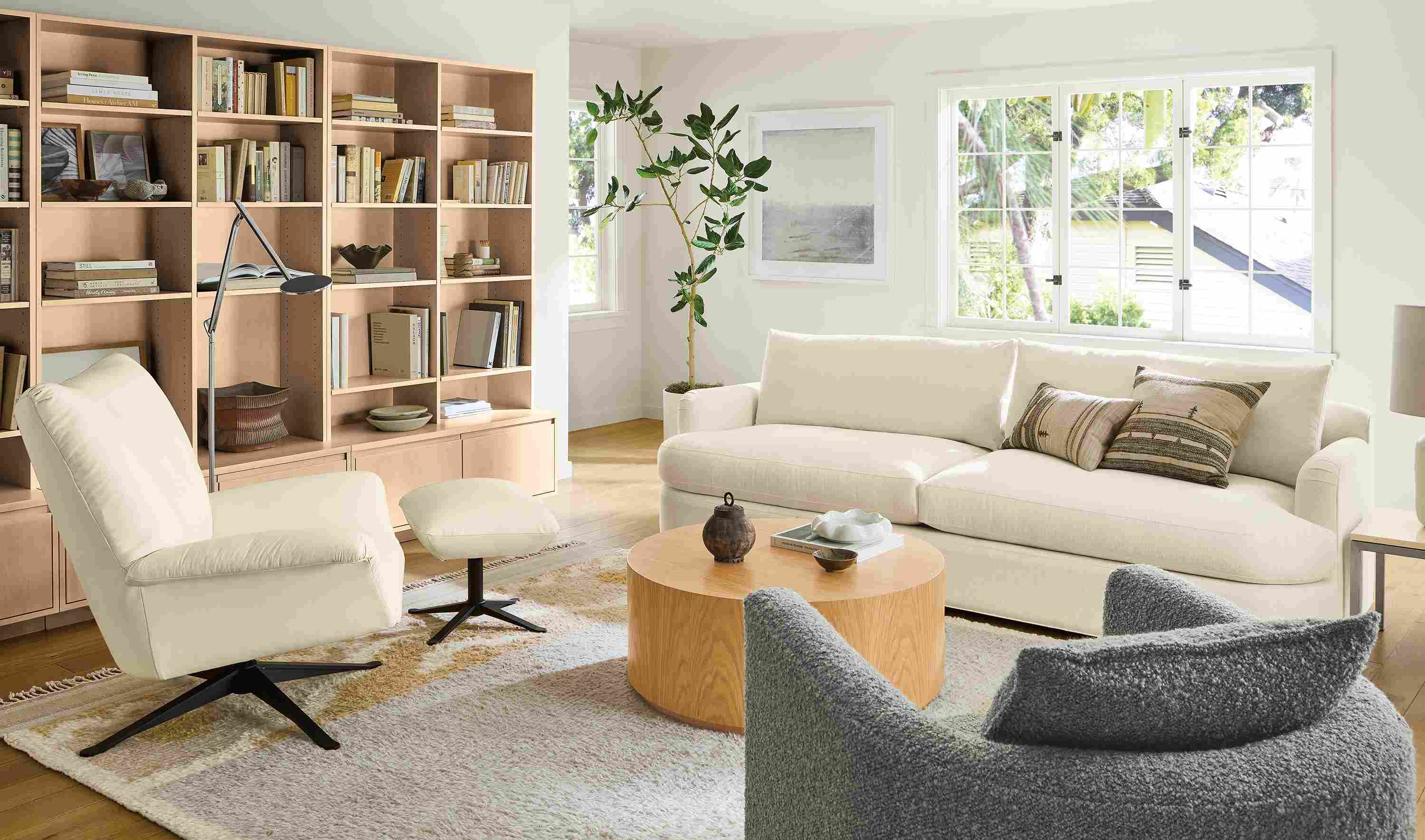 Living room with sonja sofa in hawkins ivory and paris swivel chair and ottoman in pesaro ivory with tova rug.
