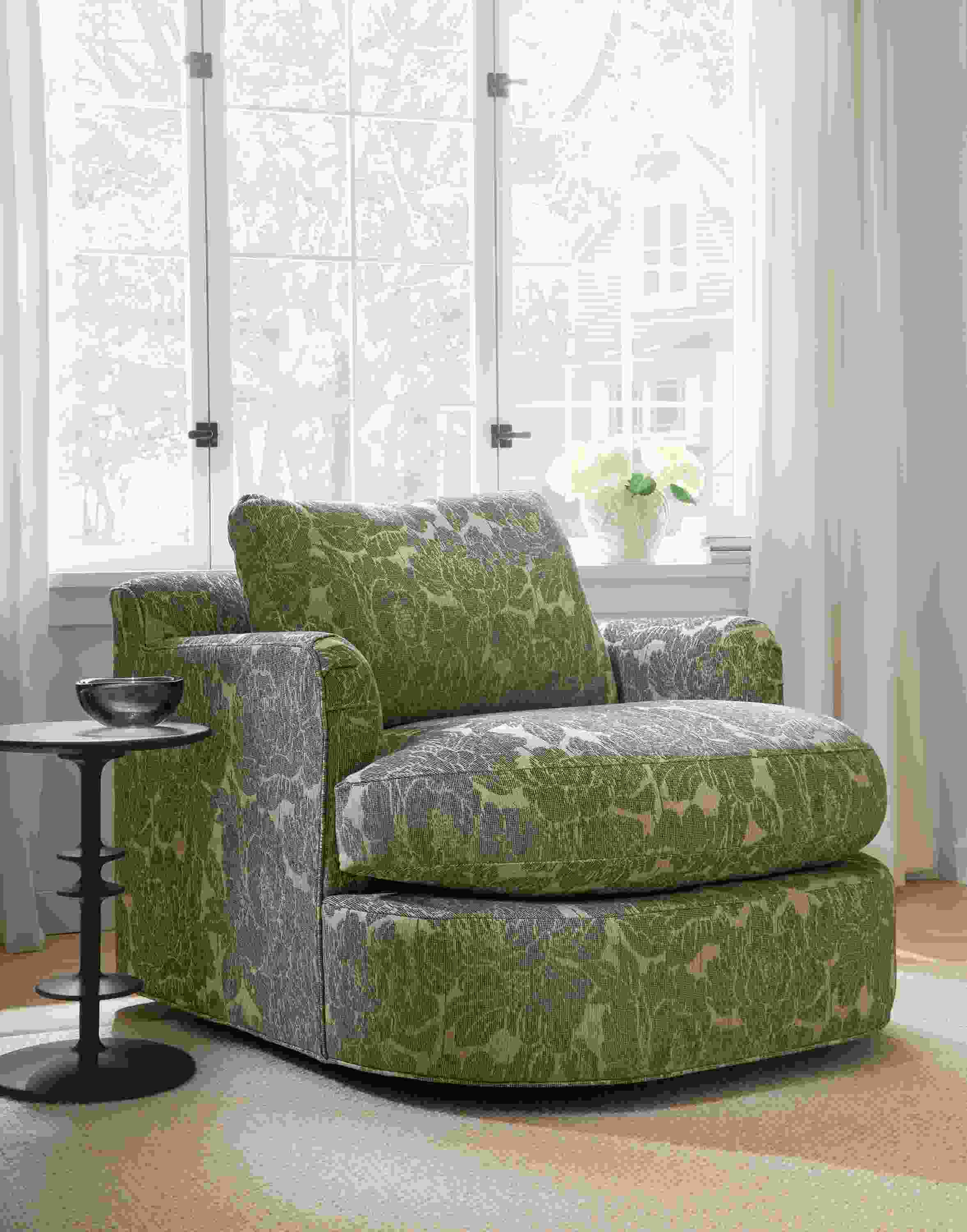 Living room with Sonja swivel chair in Caldwell Olive, Flannery rug in oatmeal and Park round end table in Charcoal.