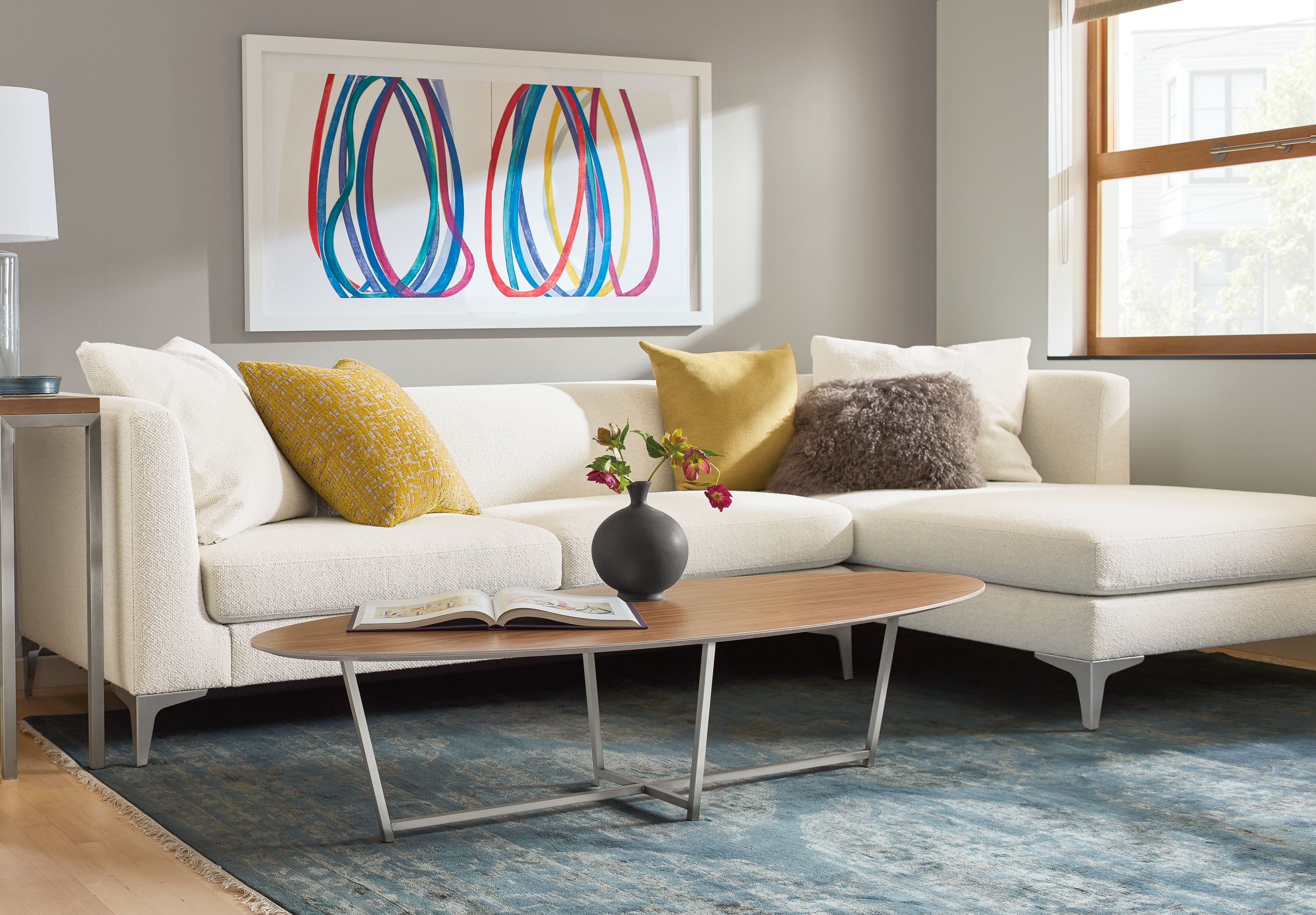 Detail of Soto oval coffee table in stainless steel and walnut.