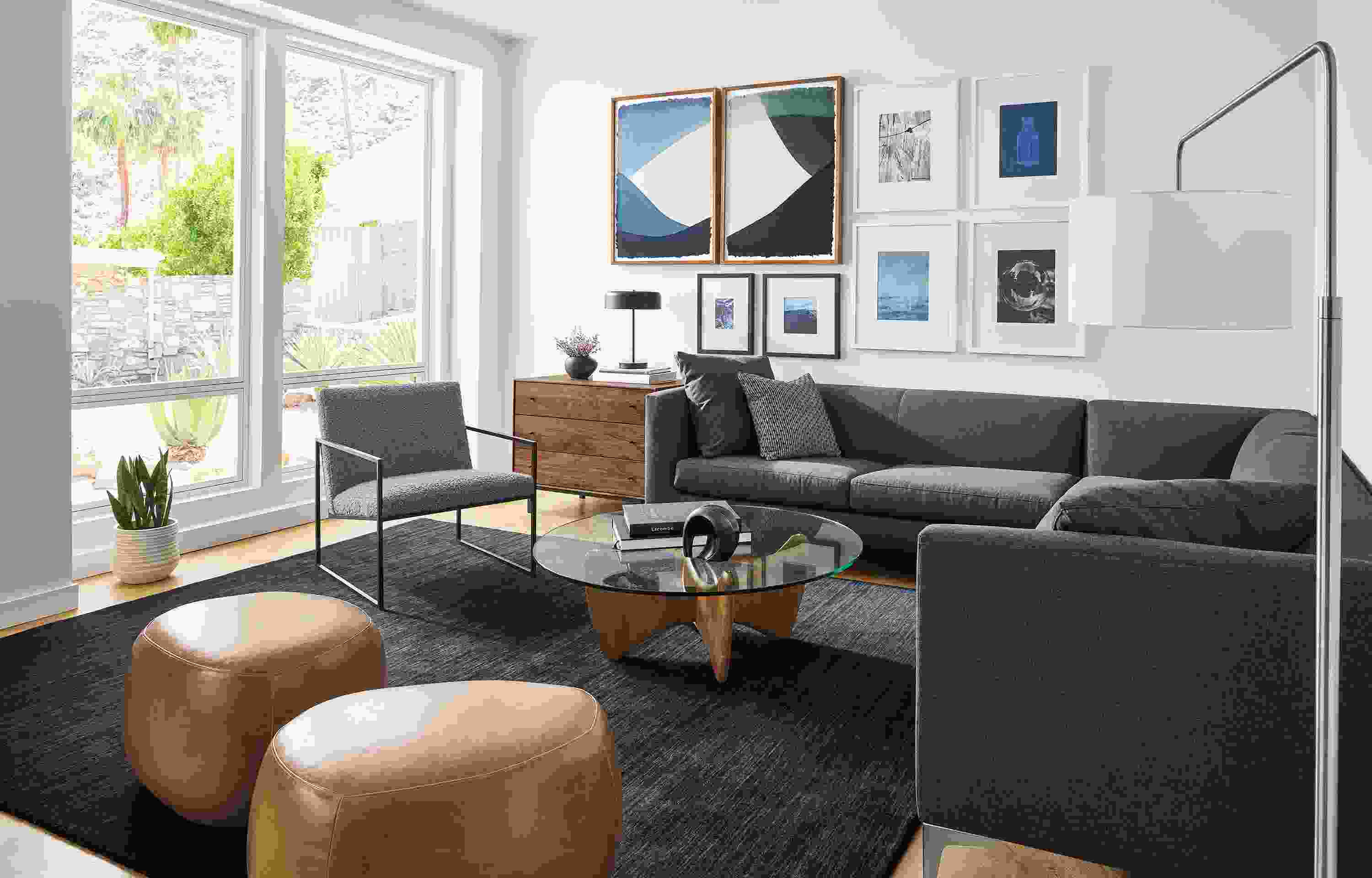 Living room with Sterling sectional in Myers Charcoal Novato chair in Dornick Haze two asher ottomans in vento cognac leather.