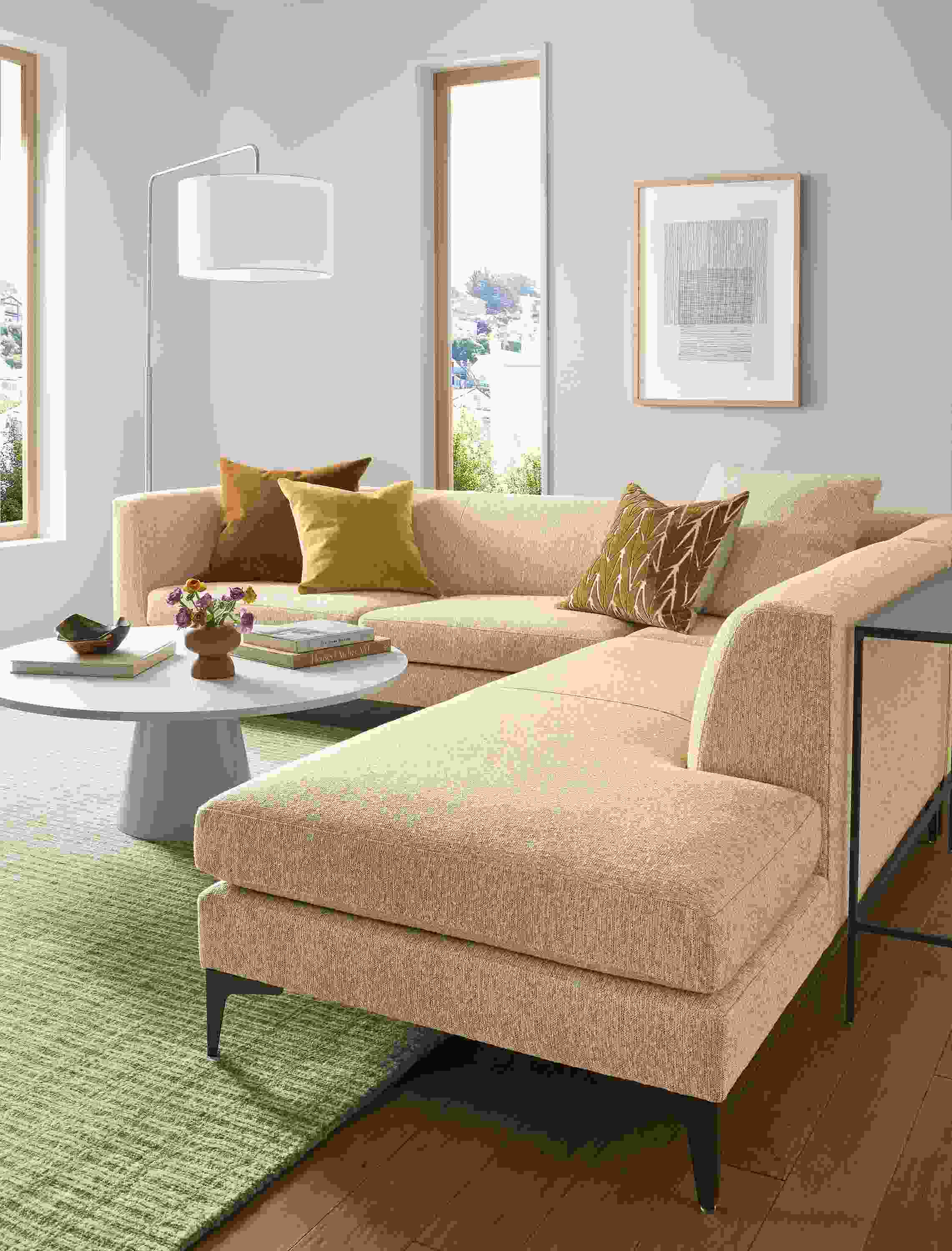 Living room with Sterling sofa in Conley Saffron, Decker 42-diameter coffee table in taupe and white quartz.