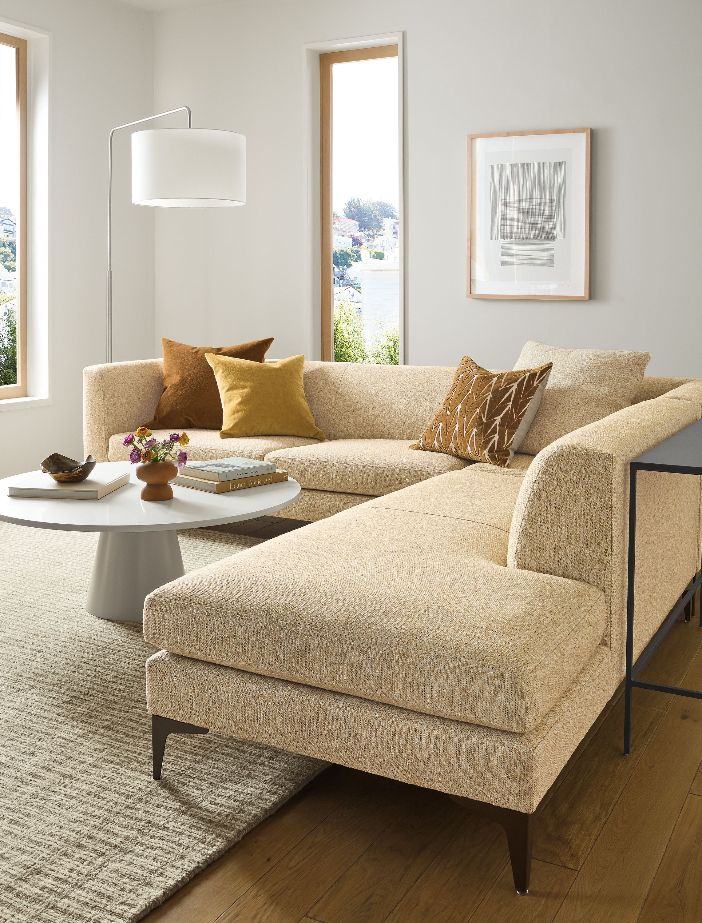 Living room with Sterling sofa in Conley Saffron, Decker 42-diameter coffee table in taupe and white quartz.