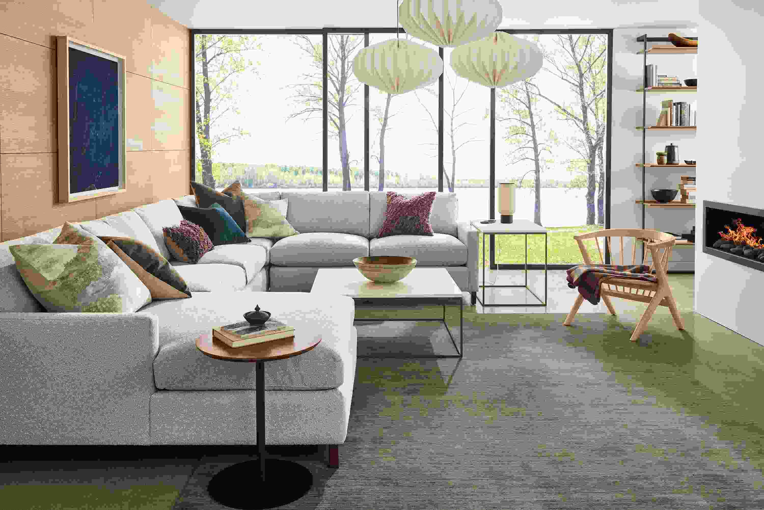 Living room with Stevens 149-wide sectional sofa in Declan Natural, Soren lounge chair in salt on red oak and Nomad rug in olive.