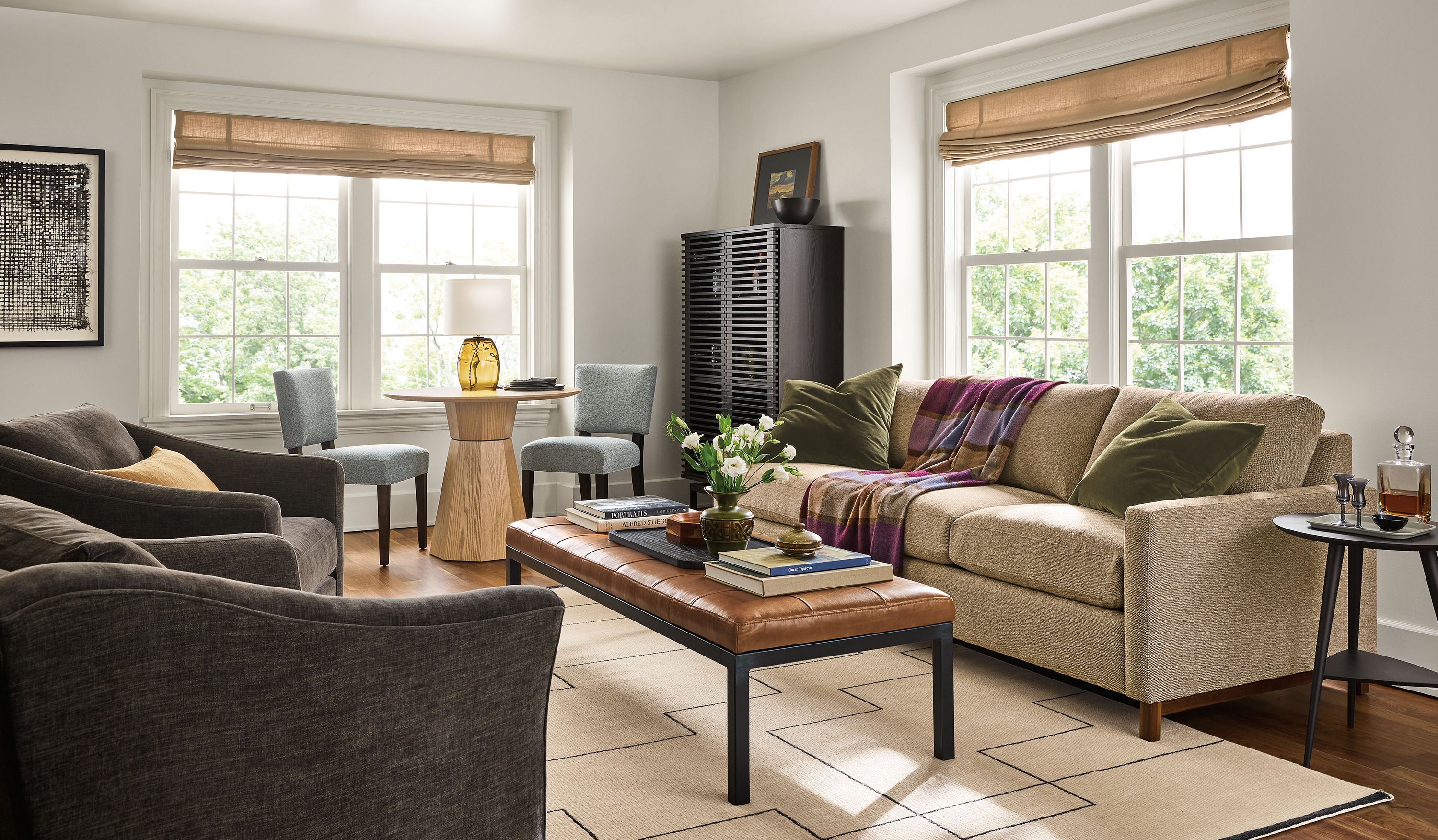 Living room with stevens 91-wide sofa in tatum taupe,2 maeve swivel chairs in mori charcoal and rae end table in charcoal.